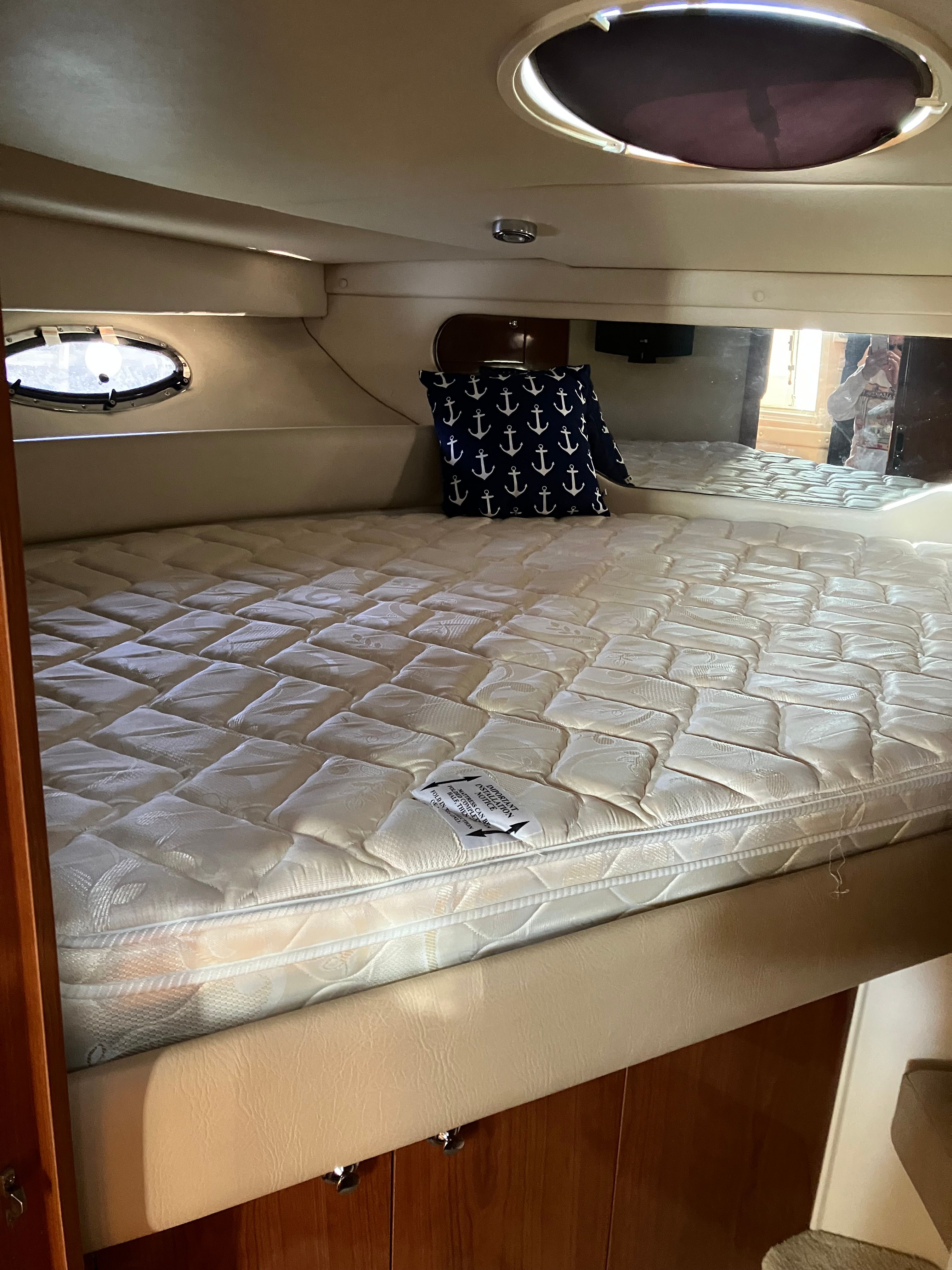 Interior of a 2008 Custom Commodore yacht with bed and anchor pillow.