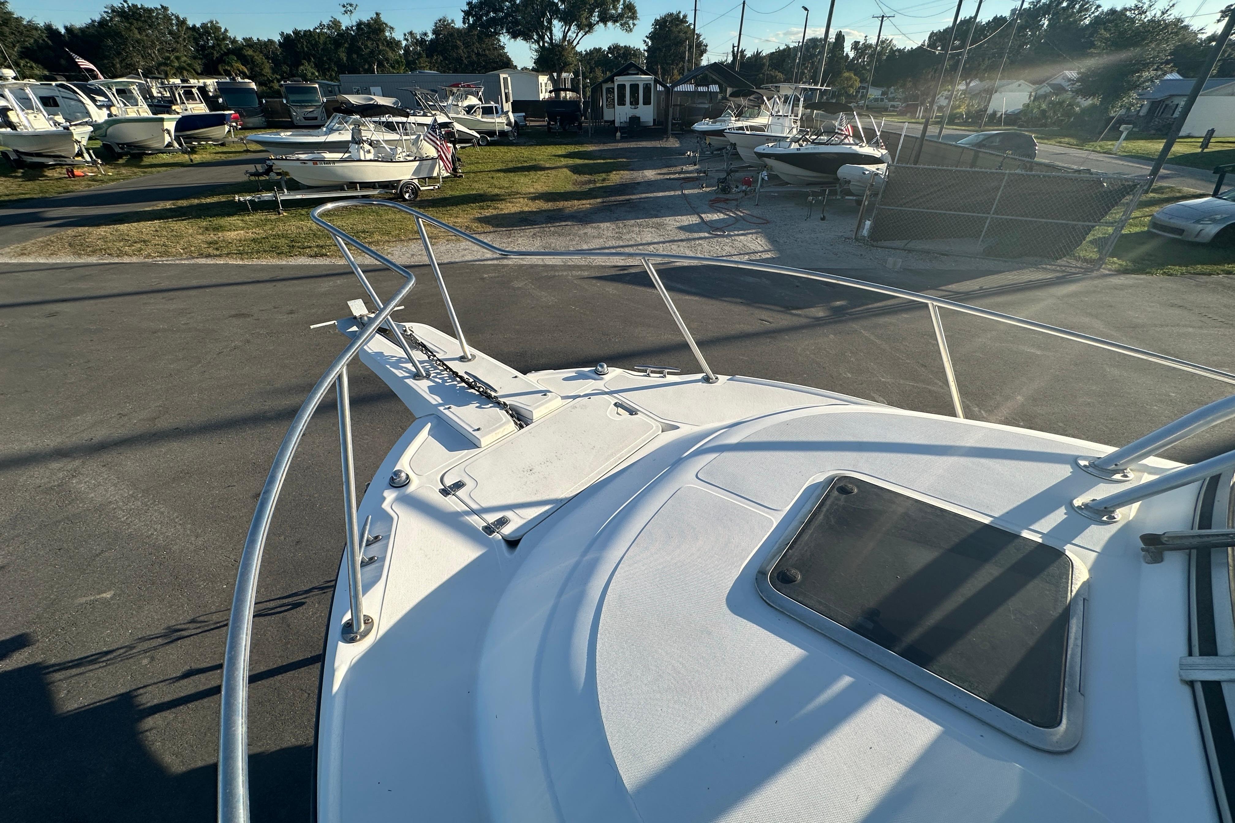 2001 Boston Whaler 23 Conquest boat deck in a marina with other boats.
