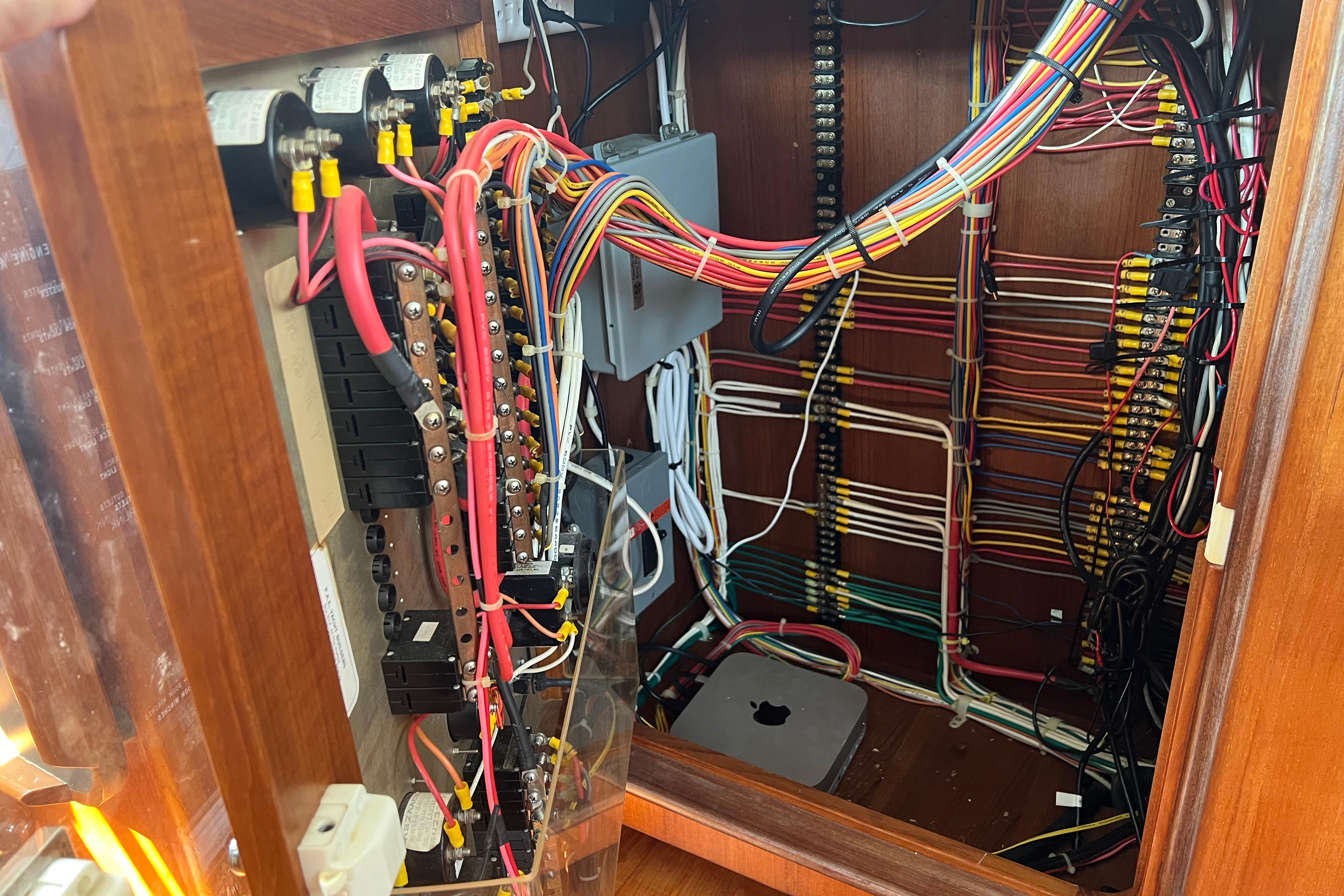 Electrical wiring panel inside a 1998 Nordhavn 46 boat, showcasing organized cables and connections.
