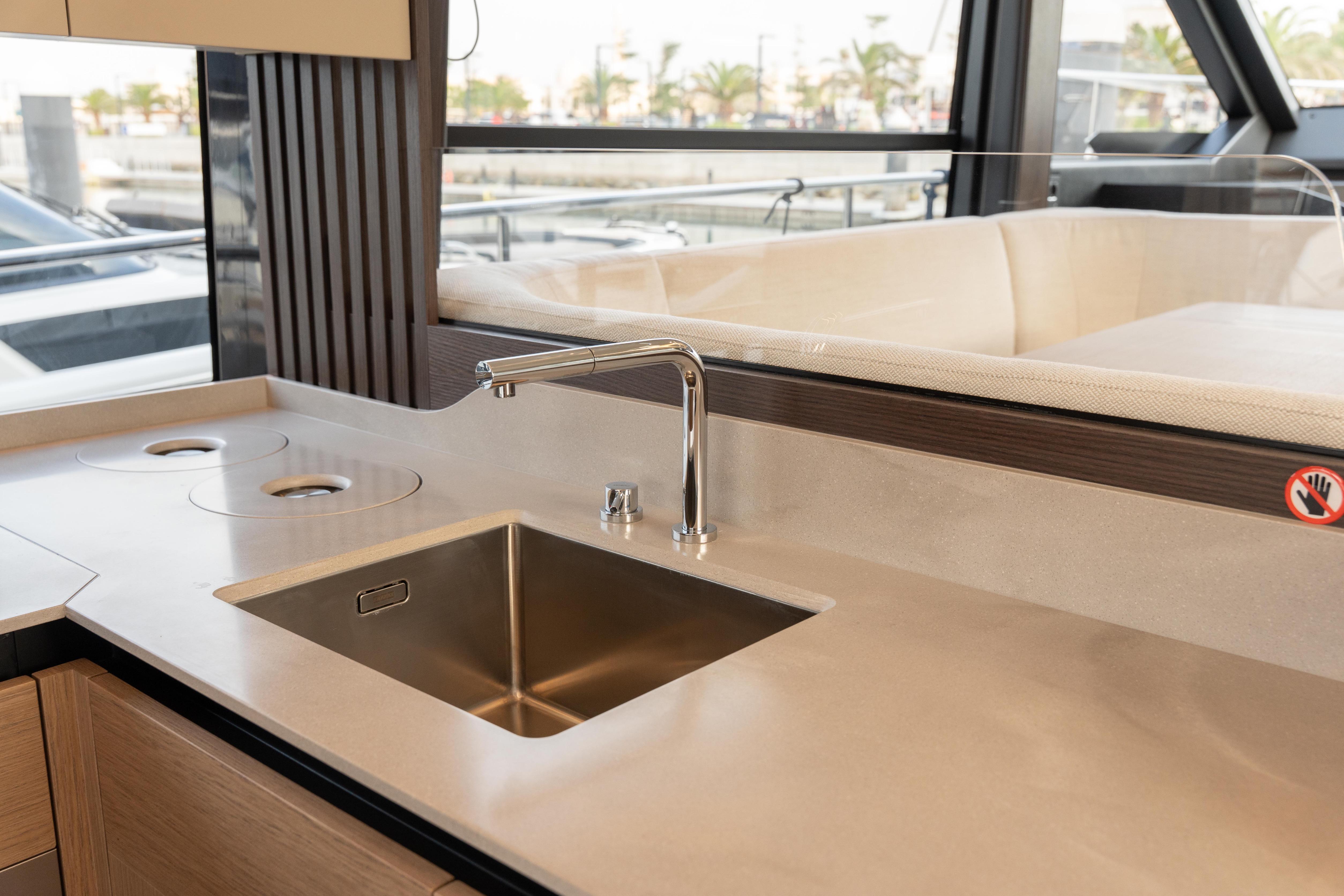 Modern kitchen sink on Absolute 52 FLY yacht, 2025 model, with sleek countertop design.
