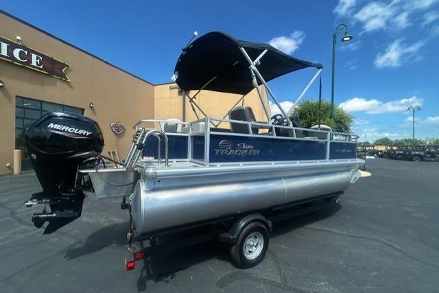 2026 Sun Tracker Bass Buggy 18 DLX pontoon boat with Mercury engine on trailer.