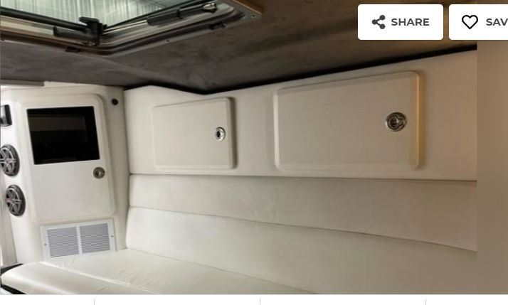 Interior of a 2003 Sunsation 32 Dominator boat with white upholstery.