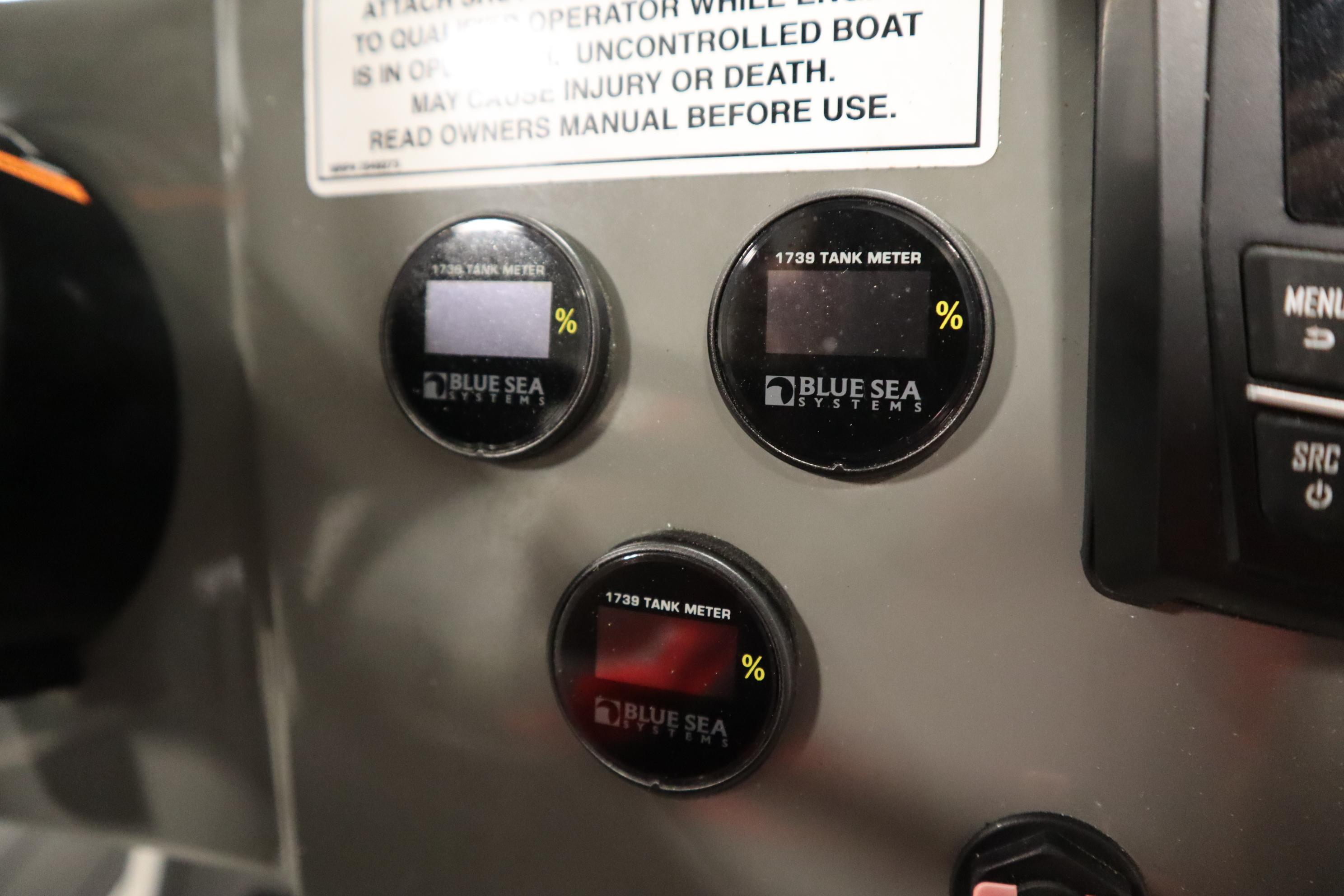 Control panel of 2023 Heyday WT Surf boat with Blue Sea Systems tank meters.