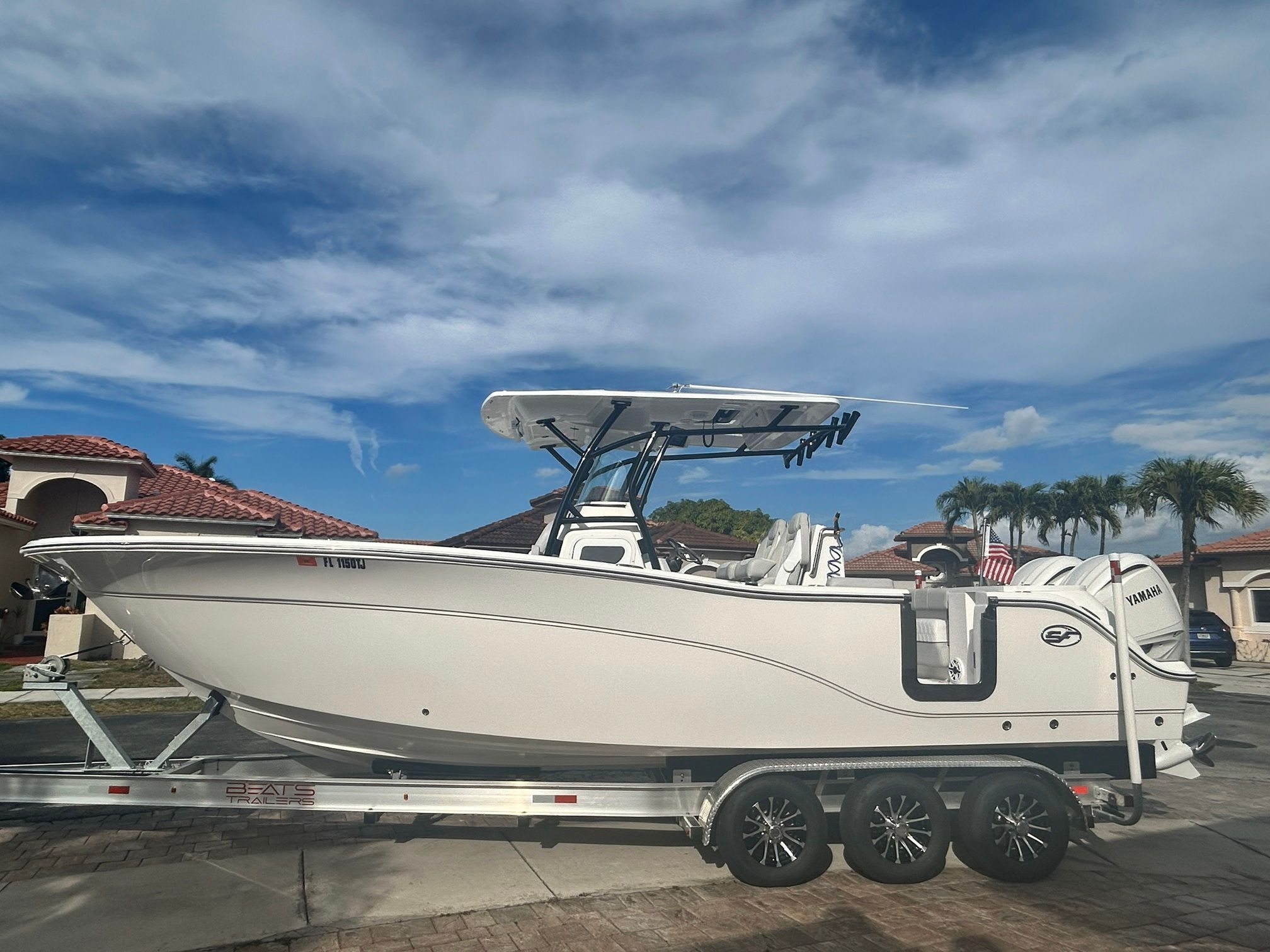 Sea Fox 288 Commander 2023 on a trailer in front of a house.