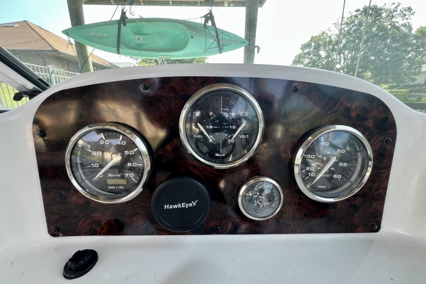 Dashboard of a 2013 Hurricane SunDeck 187 OB boat with gauges and controls.