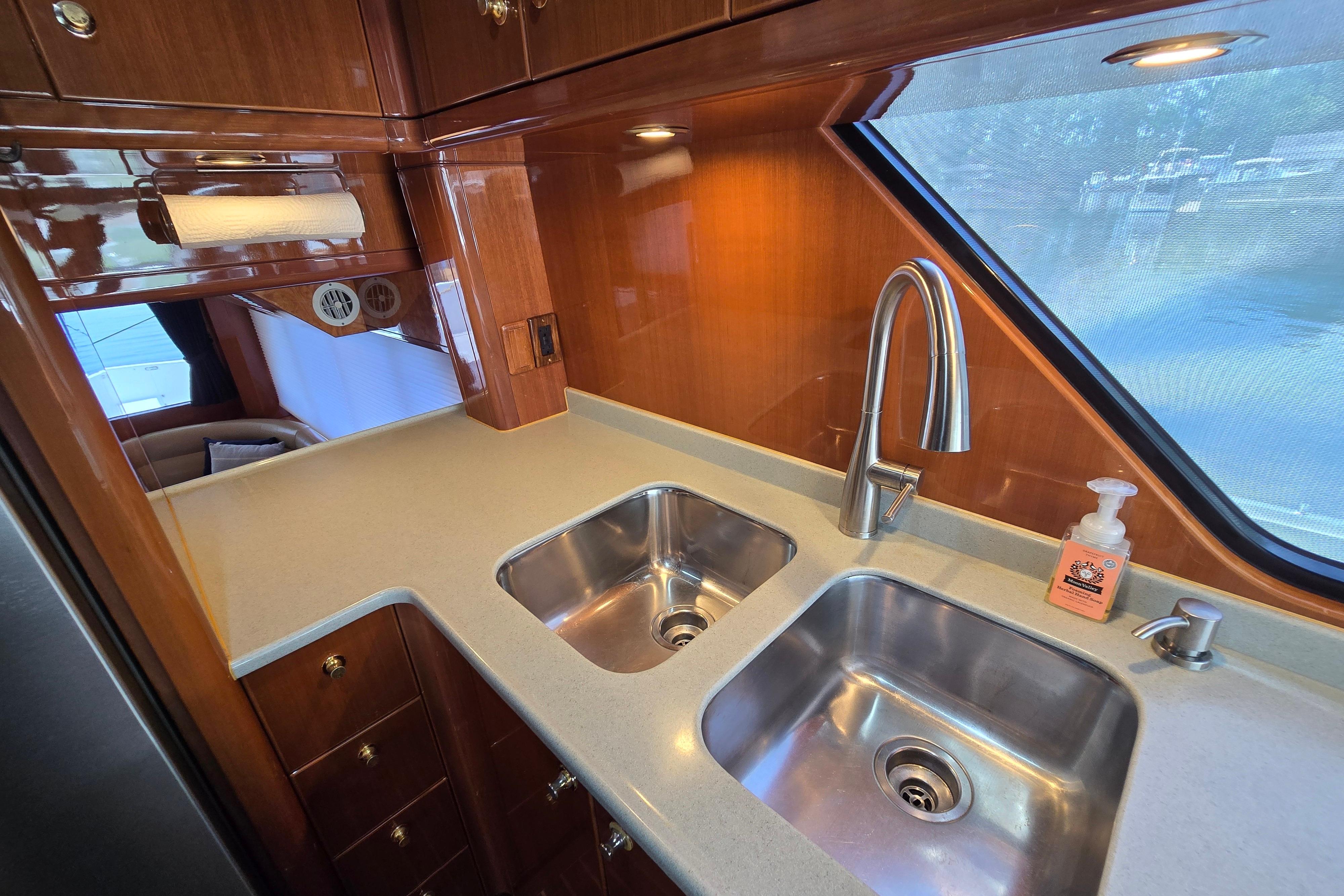 Luxurious kitchen area in a 2004 Grand Harbour 58 yacht with dual sinks.