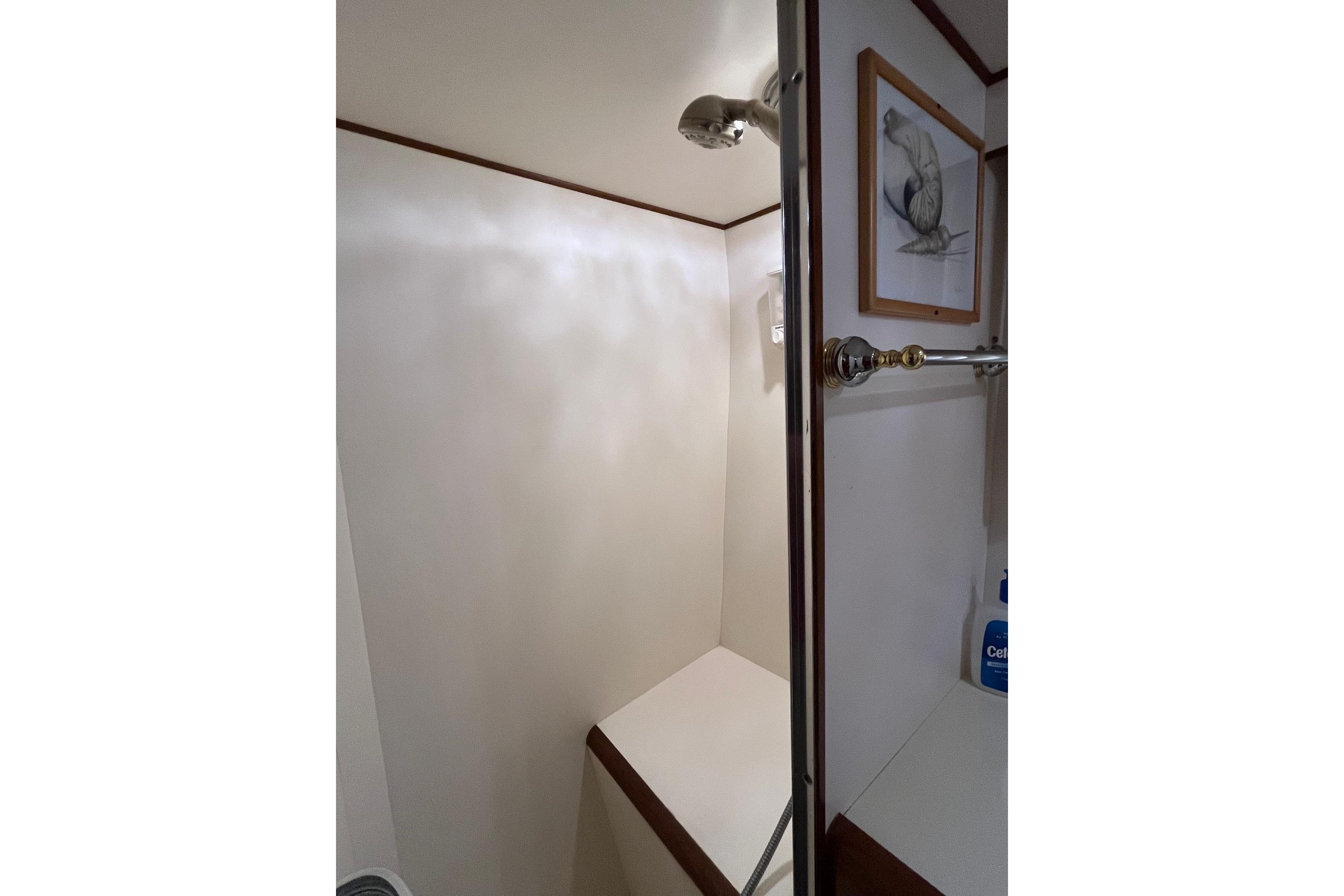 Shower area in 1989 Ocean Alexander 440 Sundeck CPMY yacht, featuring elegant fixtures and artwork.