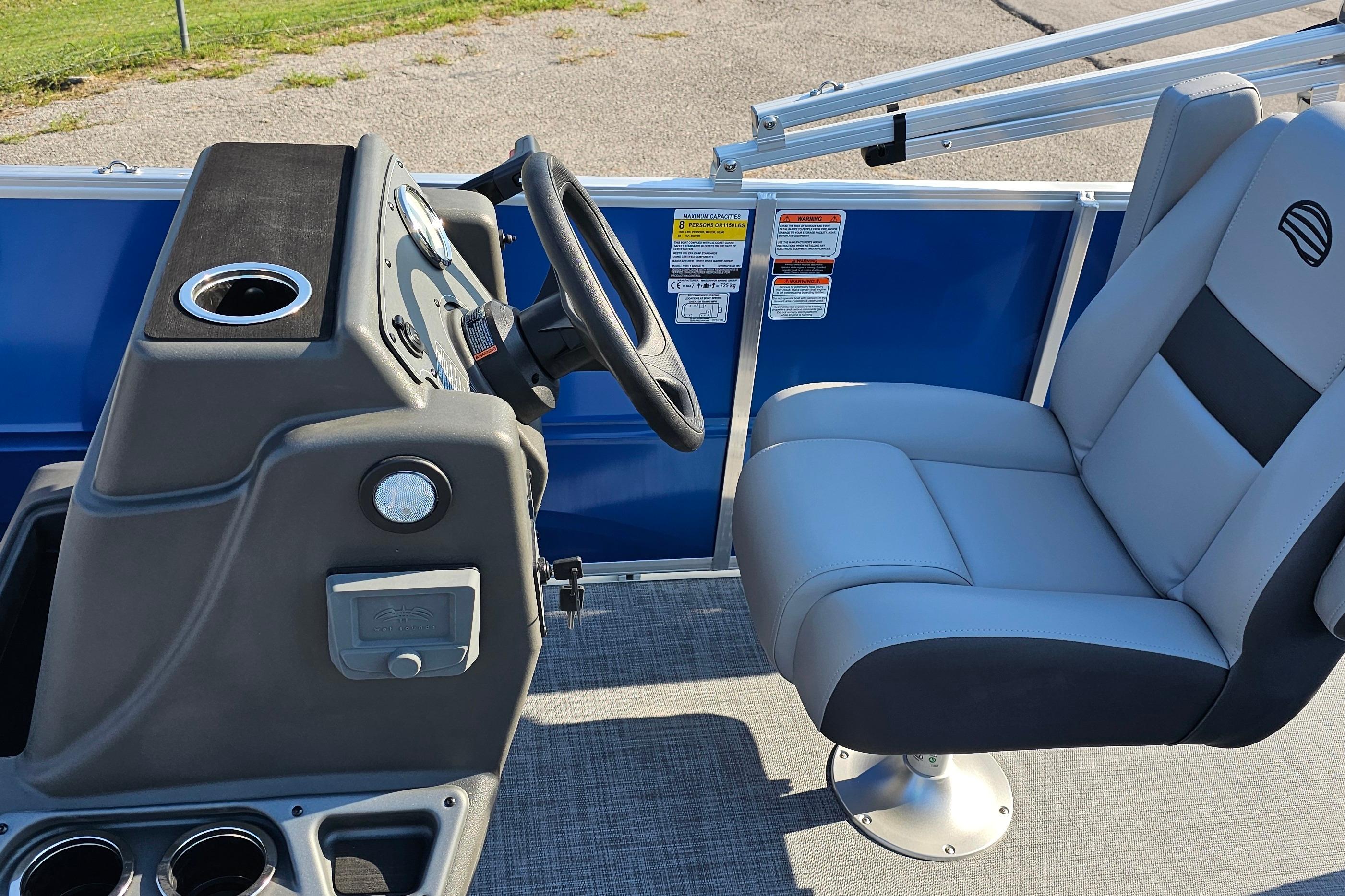 2026 Sun Tracker Party Barge 16 DLX interior with steering console and comfortable seating.
