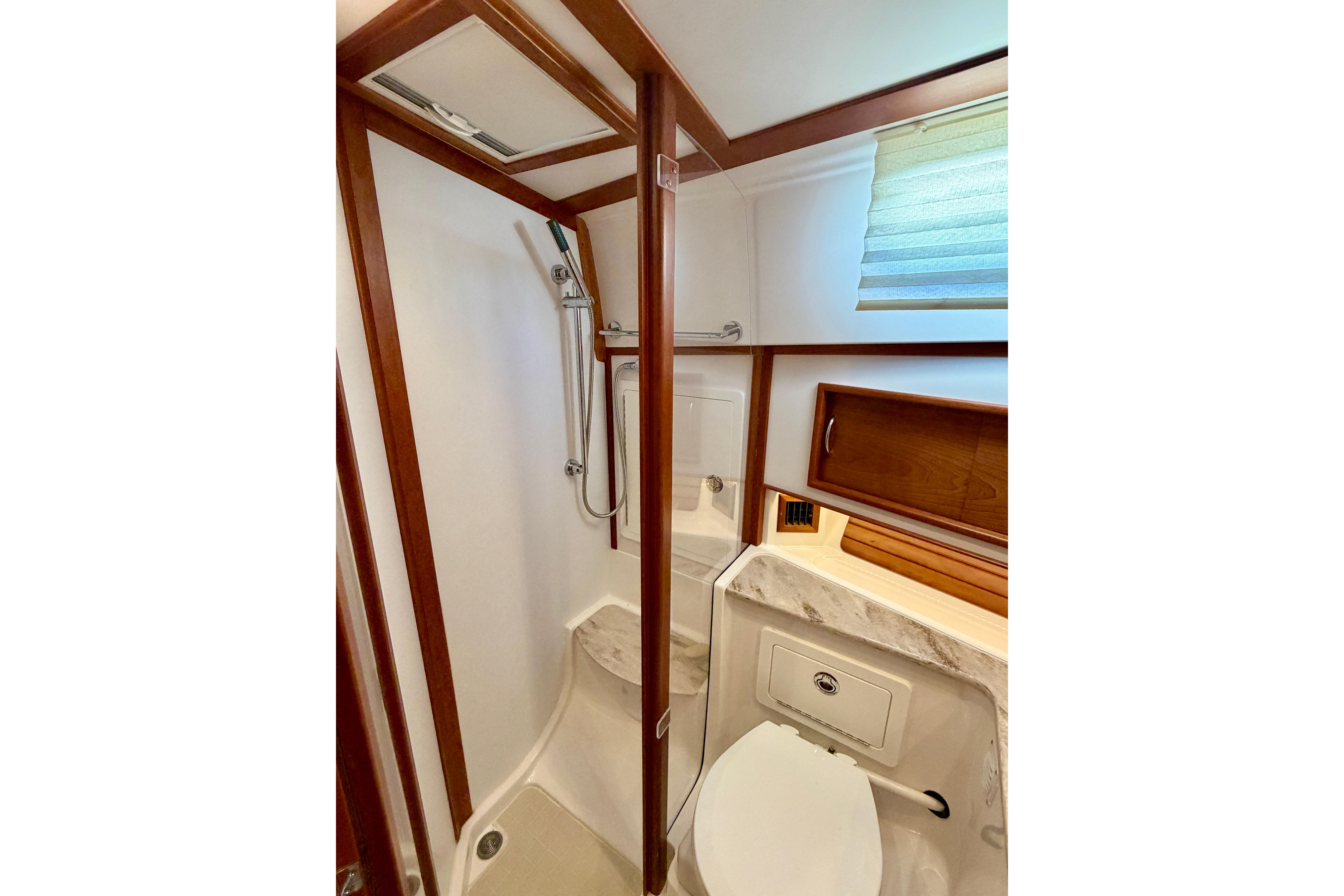 Bathroom interior of 2016 Sabre 48 Salon Express yacht, featuring shower and wooden accents.