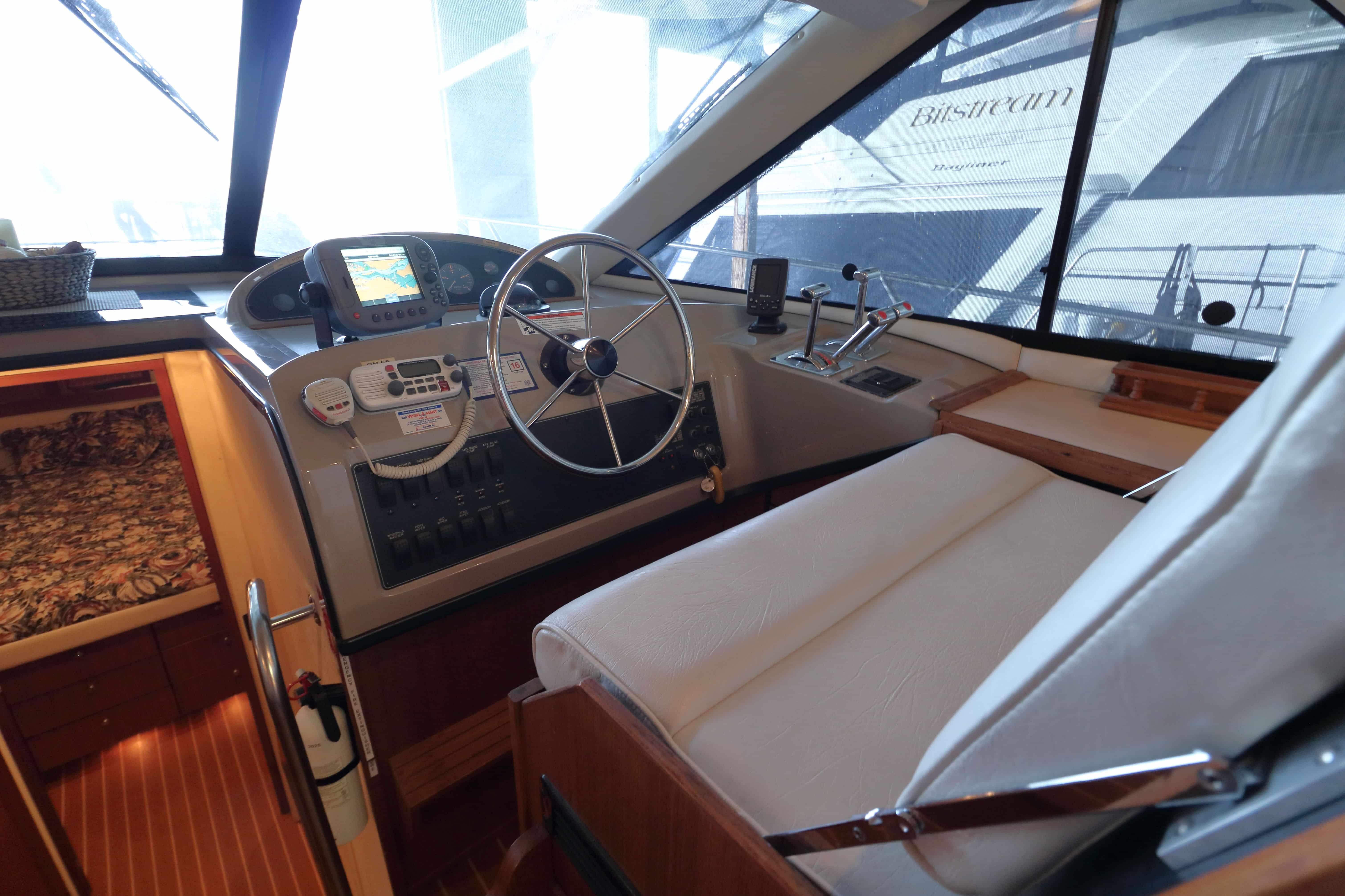 1995 Bayliner 3988 Command Bridge Motoryacht helm with steering wheel and navigation equipment.
