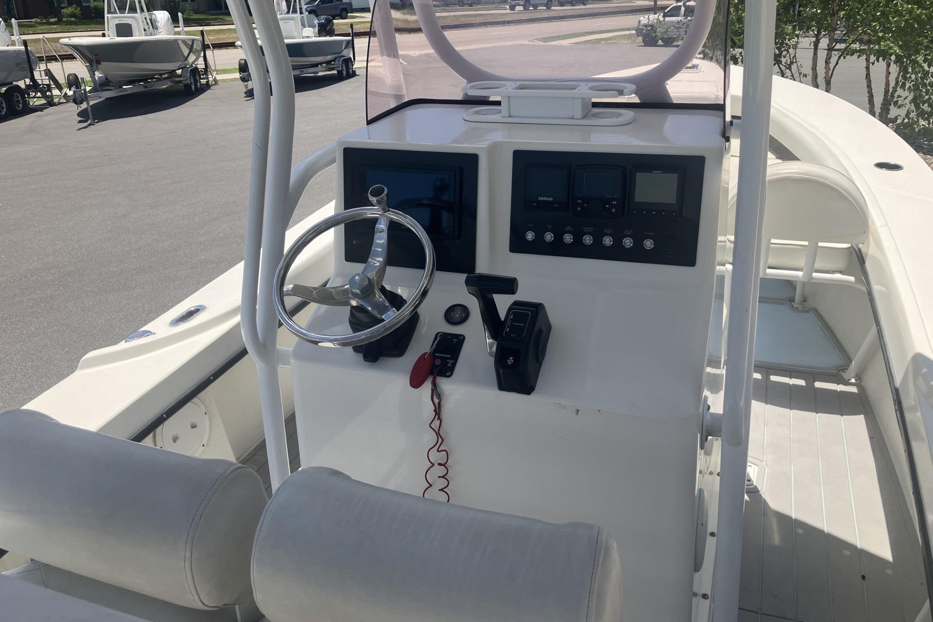 2022 May-Craft 2300 CCX boat console with steering wheel and control panel.