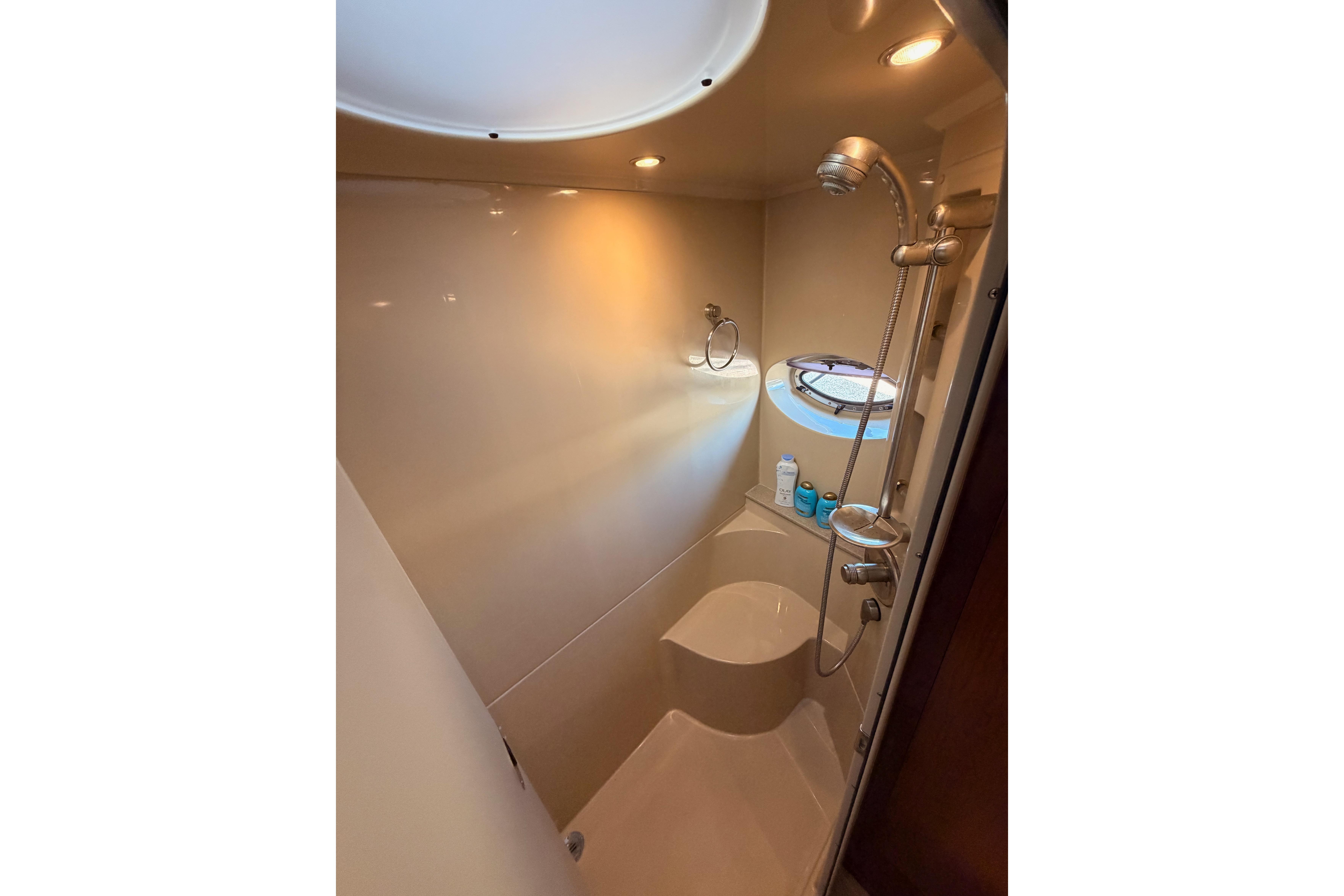 Luxurious bathroom in 2005 Cruisers Yachts 405 Express Motoryacht with modern shower amenities.