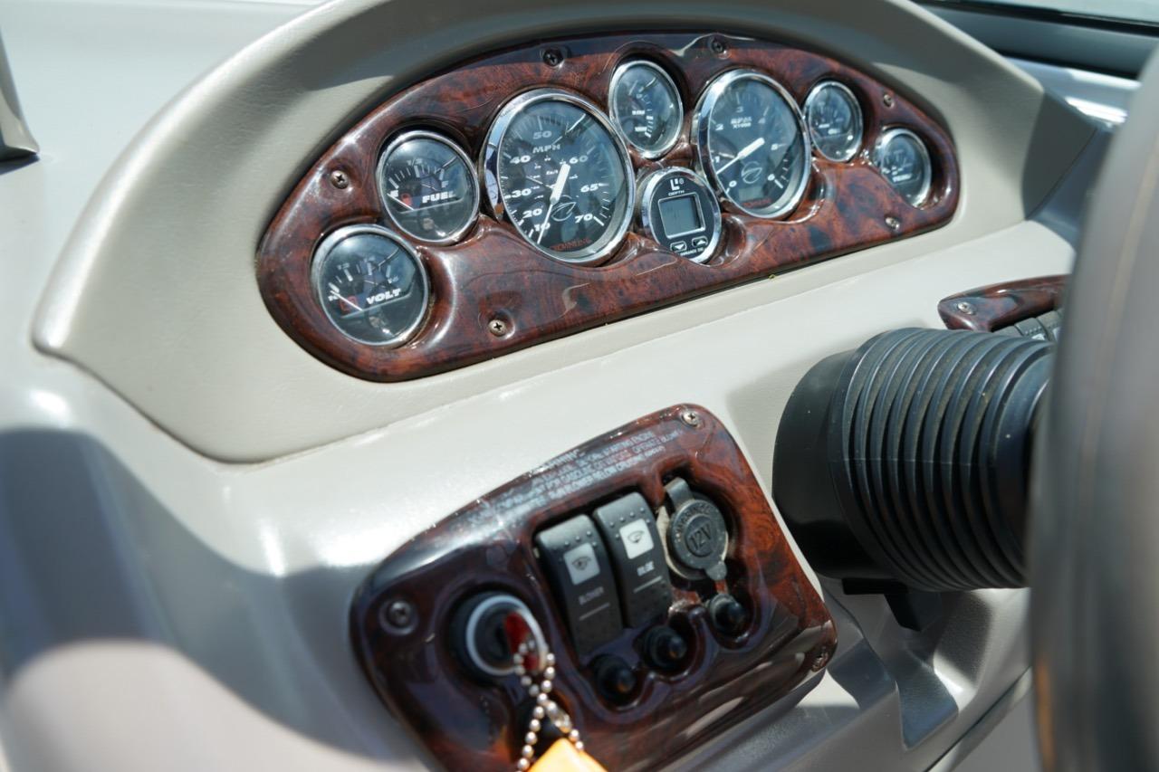 Dashboard of a 2004 Crownline 216 LS boat with gauges and controls.