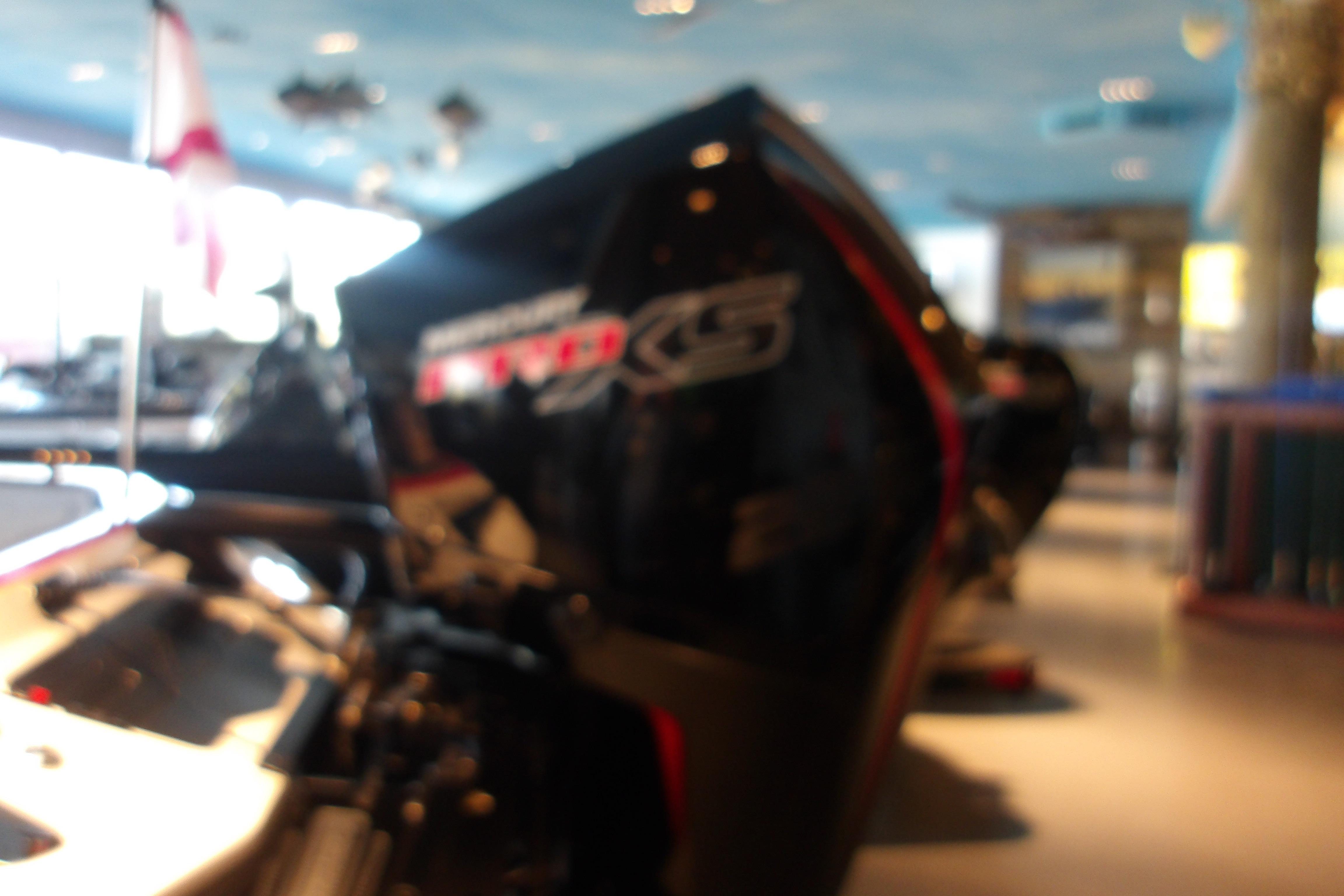 Blurry image of a 2025 Ranger Z519R Cup-Equipped boat in a showroom setting.