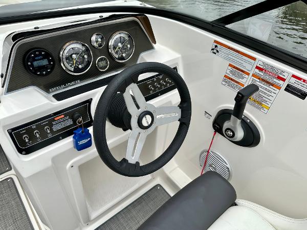 2022 Bayliner DX 2050 boat dashboard with steering wheel and control panel.