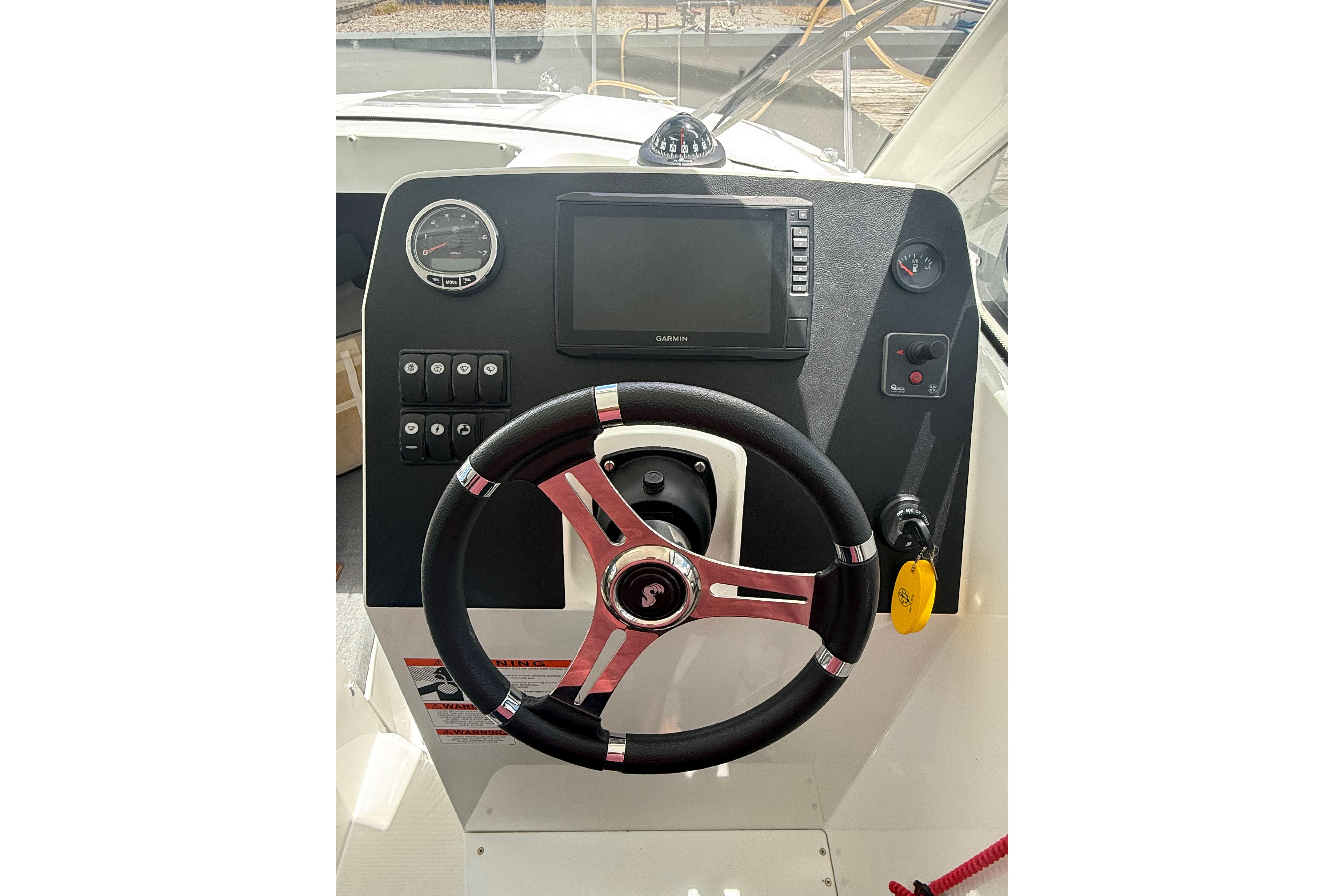 Steering console of a 2019 Beneteau Antares 23 boat with navigation controls.