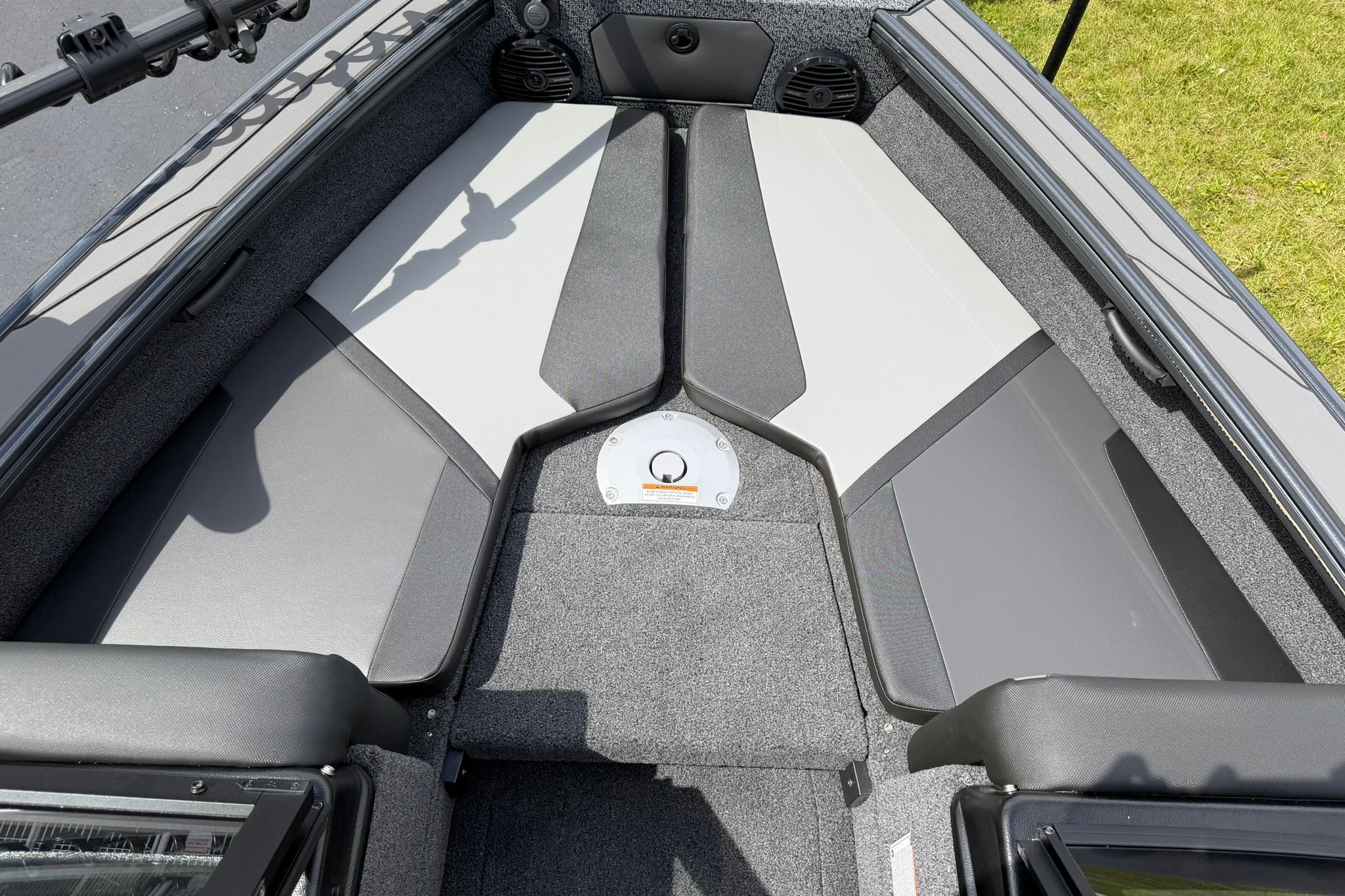 2027 Lund 1875 Crossover XS boat interior with gray seating and carpeted flooring.