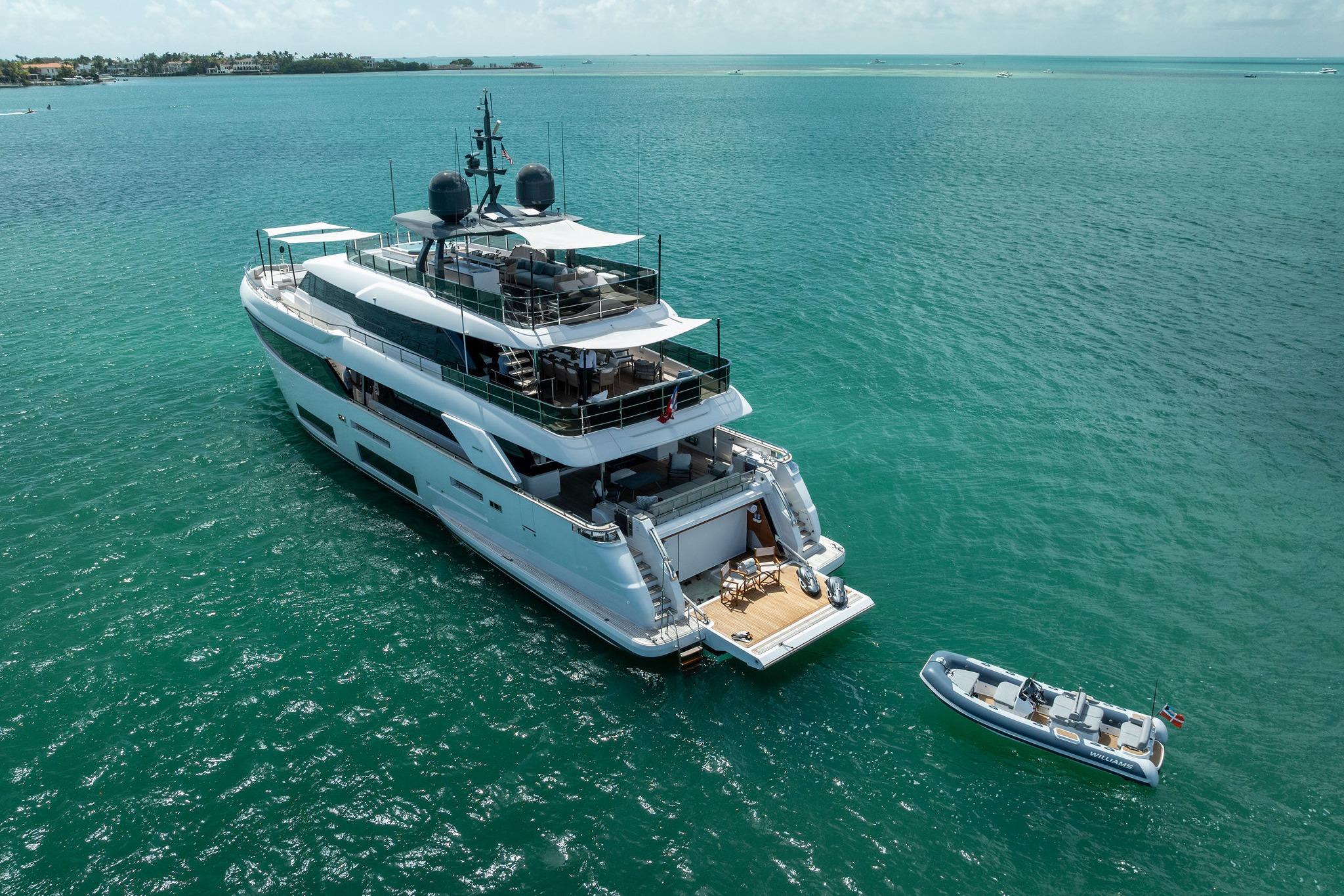 Luxurious 2023 Custom Line Navetta 33 yacht on turquoise ocean waters.