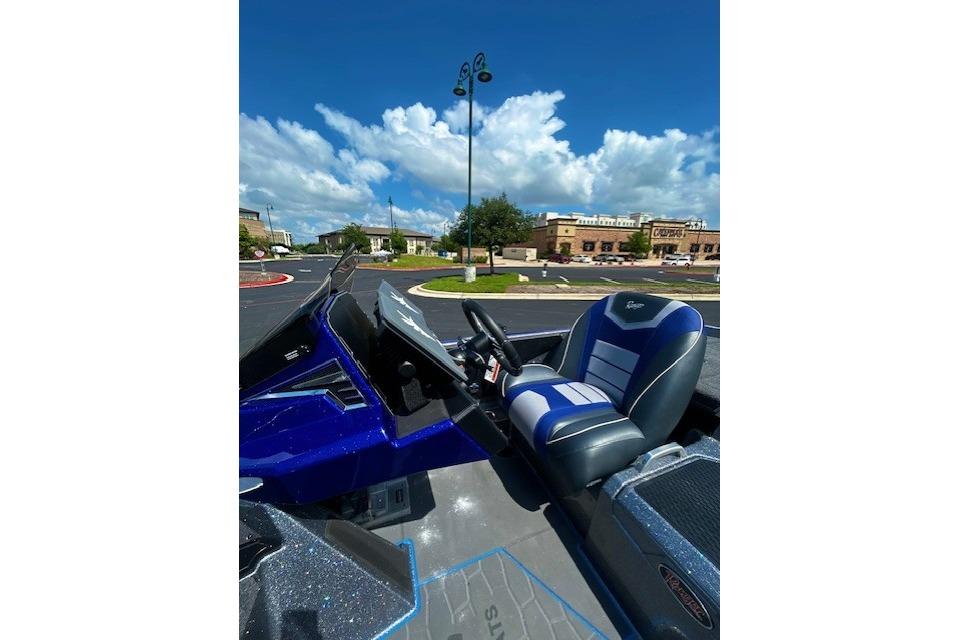 2026 Ranger Z521 boat interior with blue and white seating under a clear sky.