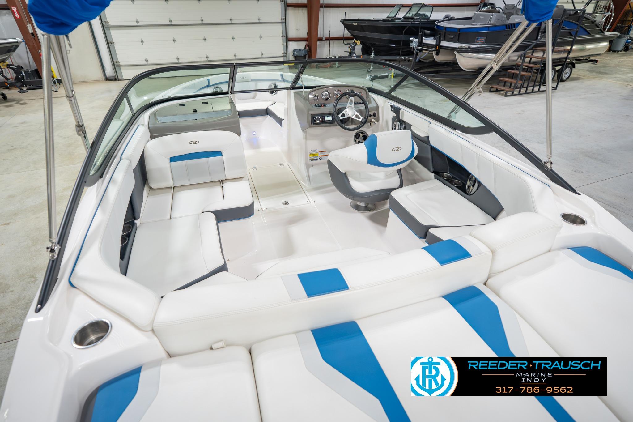2015 Regal 2000 ESX Bowrider interior with white and blue seating in showroom.