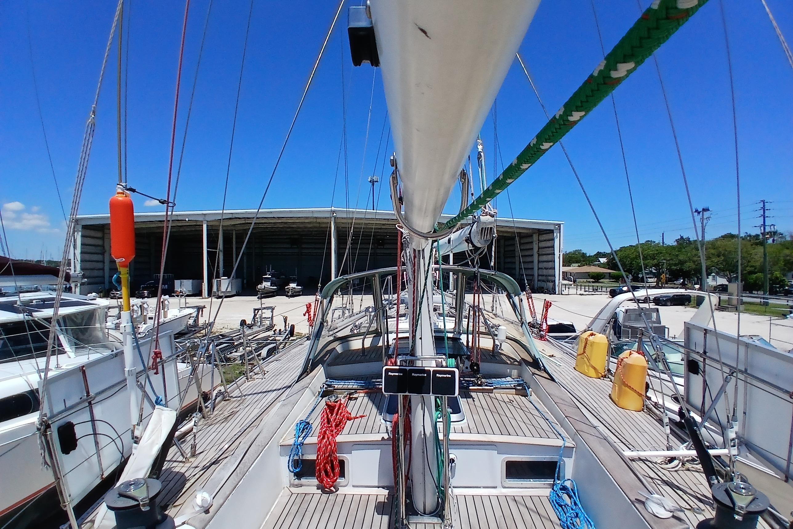 1981 Kaufman Skye 51 sailboat docked at marina under clear blue sky.