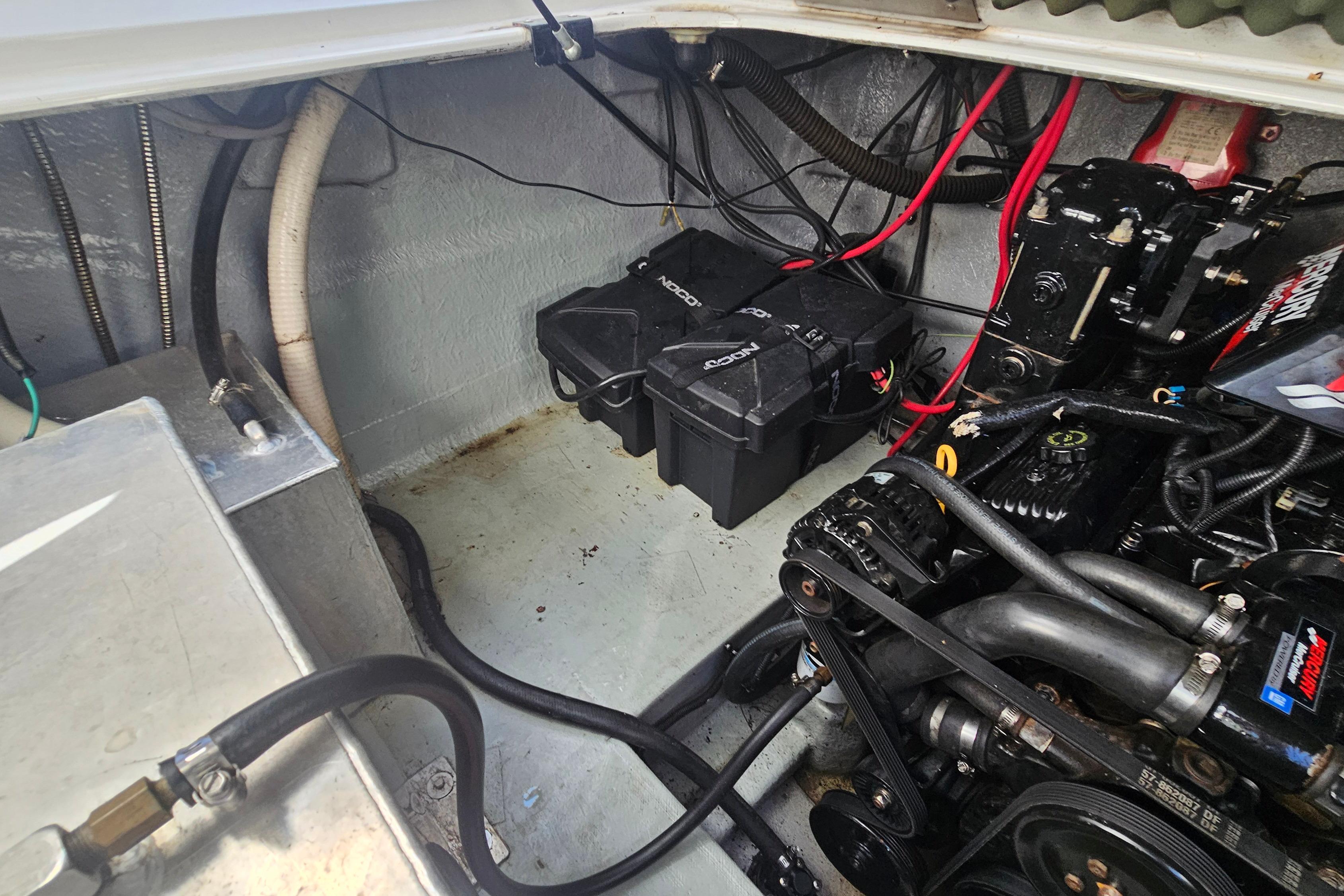Engine compartment of a 2000 Crownline 242 CR boat, showing battery and wiring.