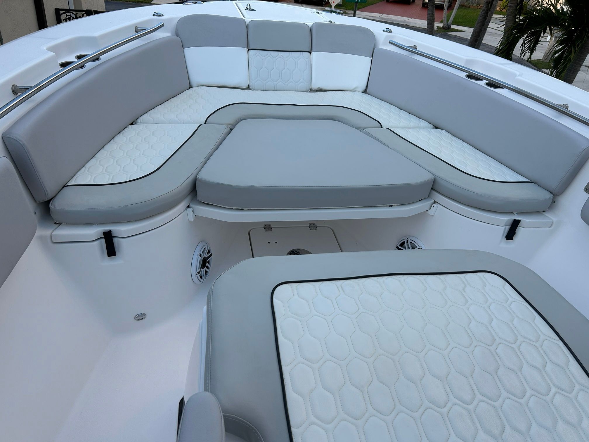 The 2023 Sea Fox 288 Commander features a spacious, cushioned seating area with gray and white upholstery.