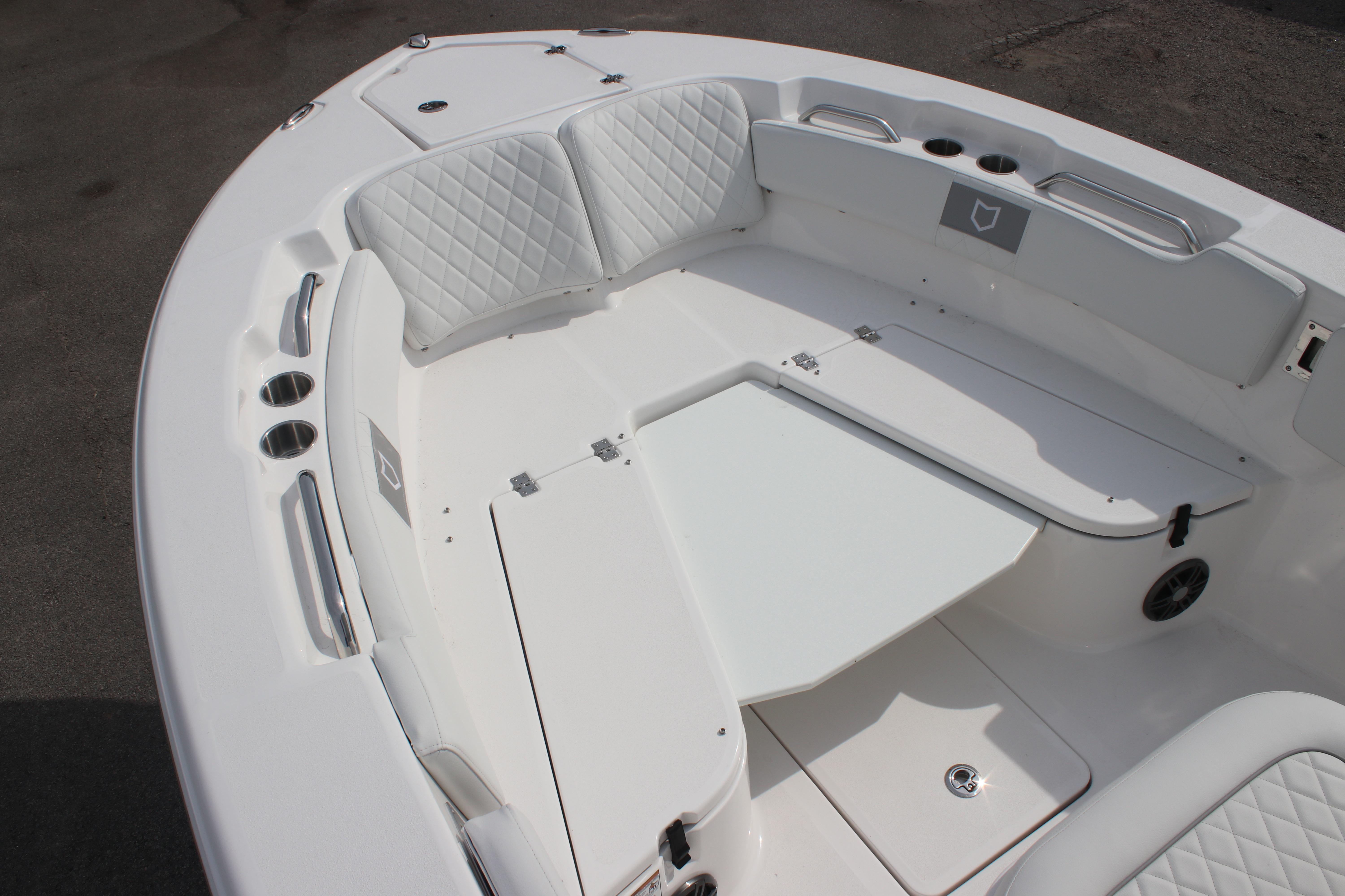 2026 Sea Fox 248 Commander boat interior with white seating and storage compartments.
