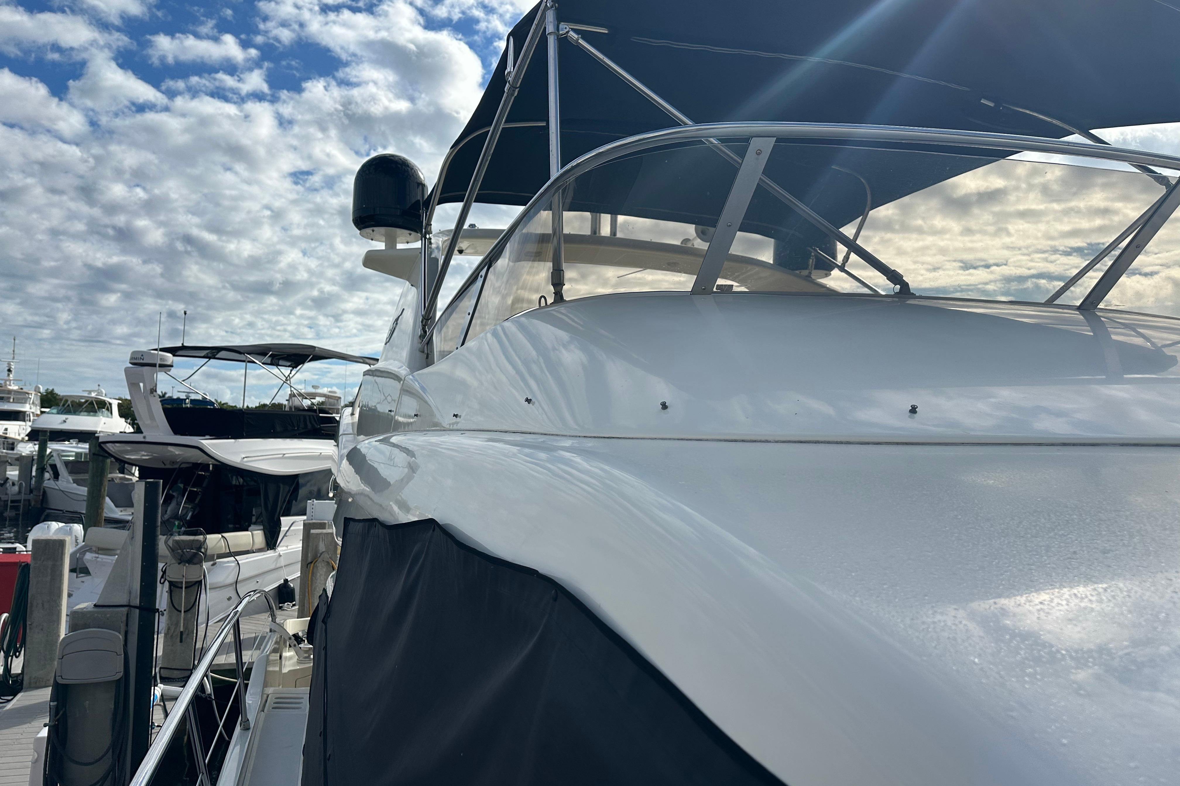 2004 Azimut 55E yacht docked under a partly cloudy sky.