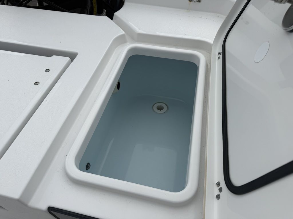 An open storage compartment on a 2025 Sportsman Masters 247OE Bay Boat.