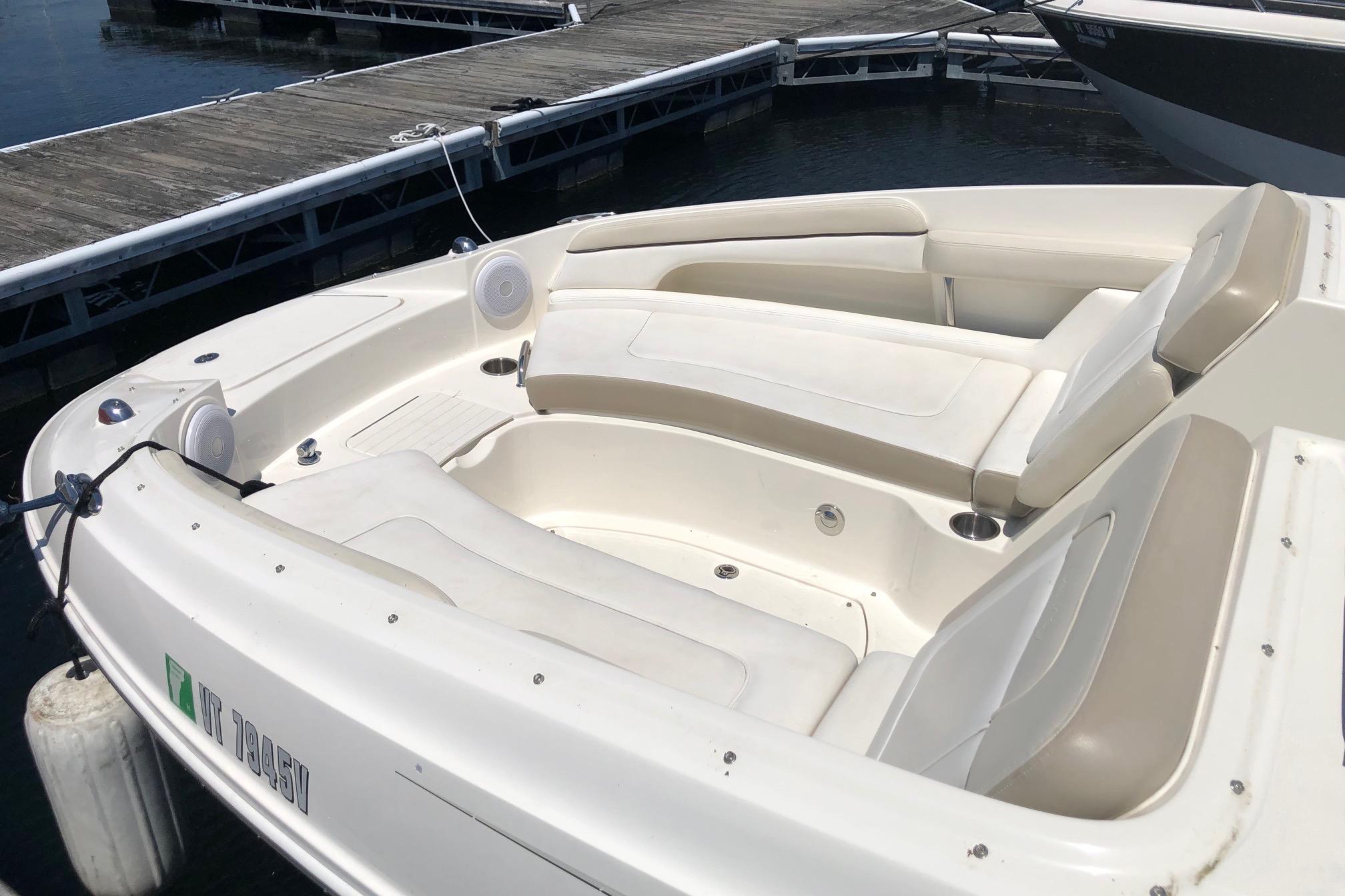 2013 Sea Ray 260 Sundeck boat docked, featuring spacious seating and sleek design.