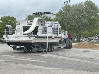 A 1993 Gibson Sport Series boat on a trailer, parked on land.