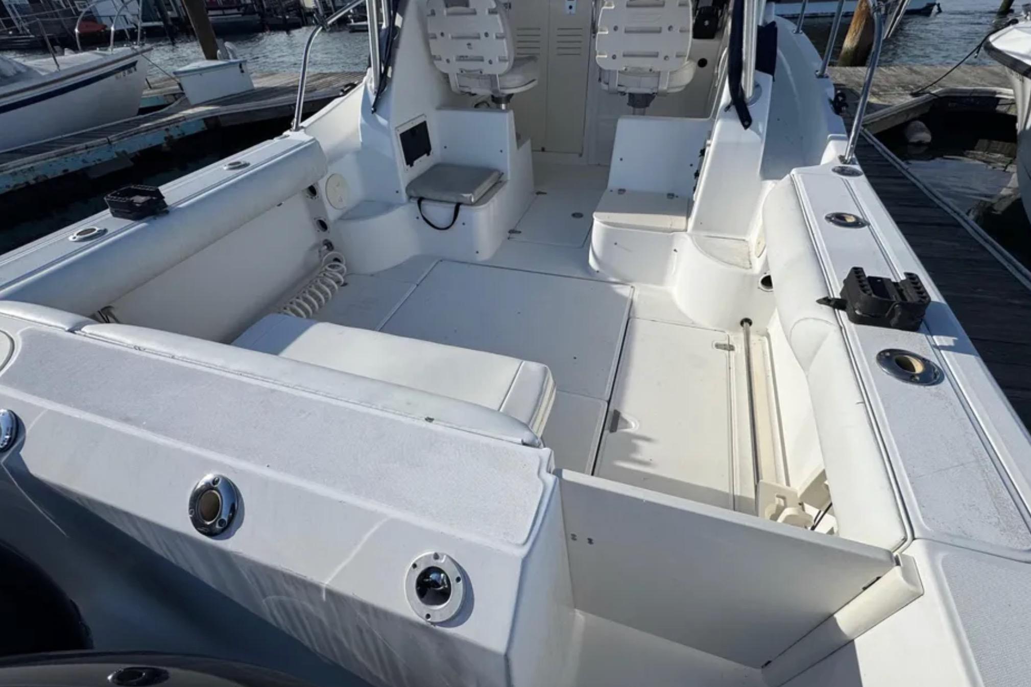 2004 Boston Whaler 255 Conquest boat interior with seating and storage compartments.