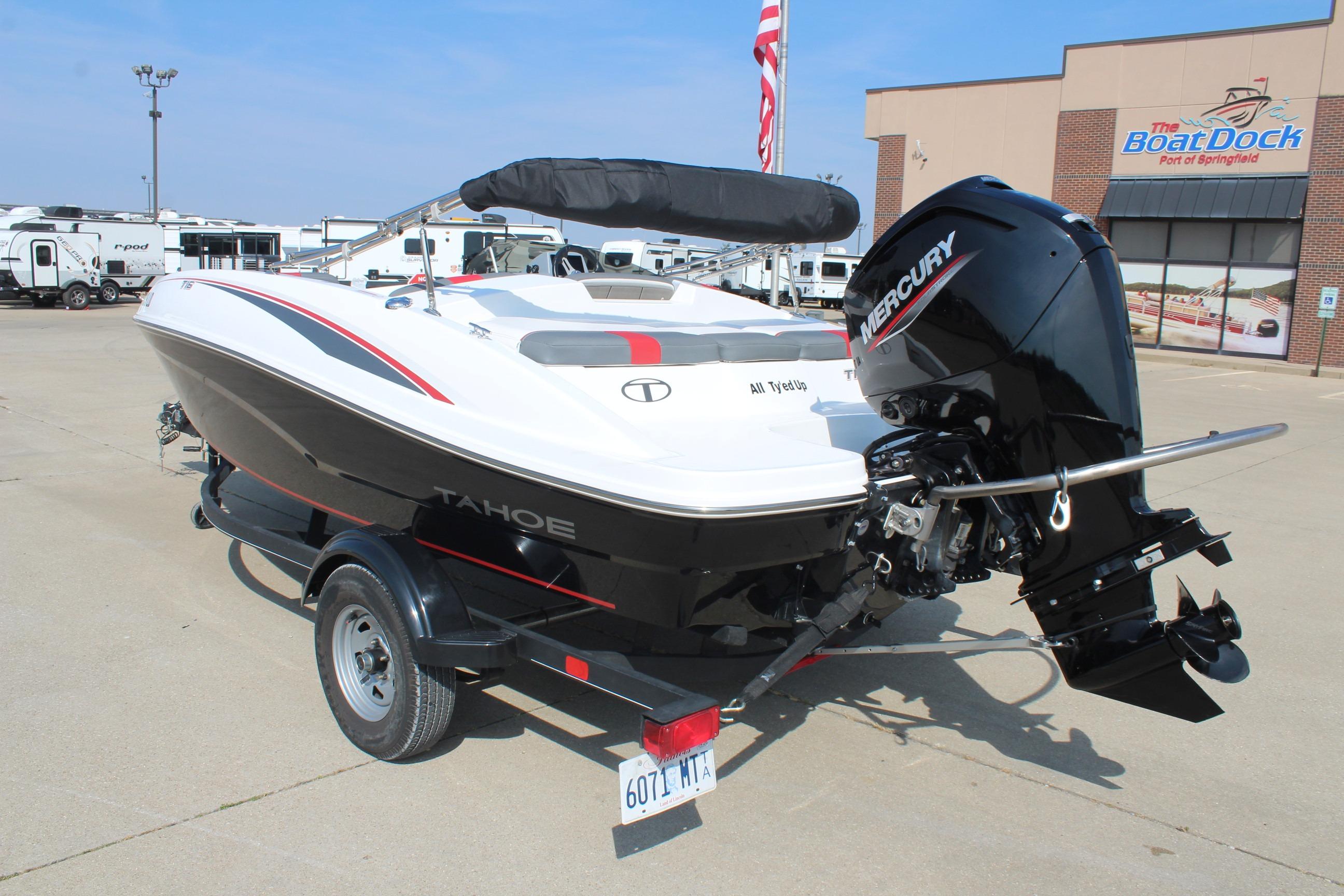 2023 Tahoe T16 boat with Mercury engine on trailer at dealership.