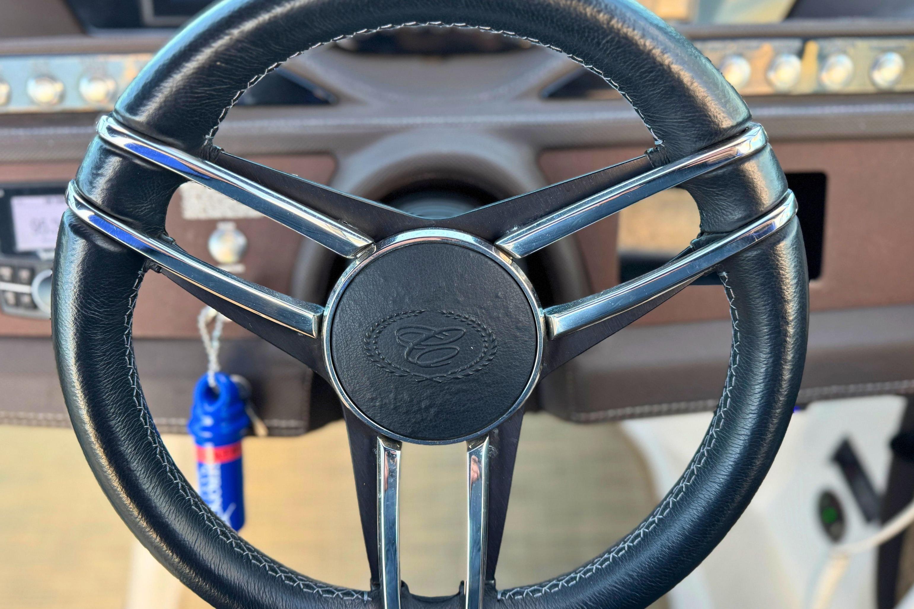 Steering wheel of a 2019 Cobalt R3 boat, featuring sleek design and leather finish.