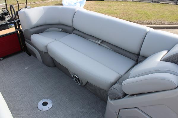 2025 Regency 230 DL3 boat interior with gray cushioned seating and speaker.