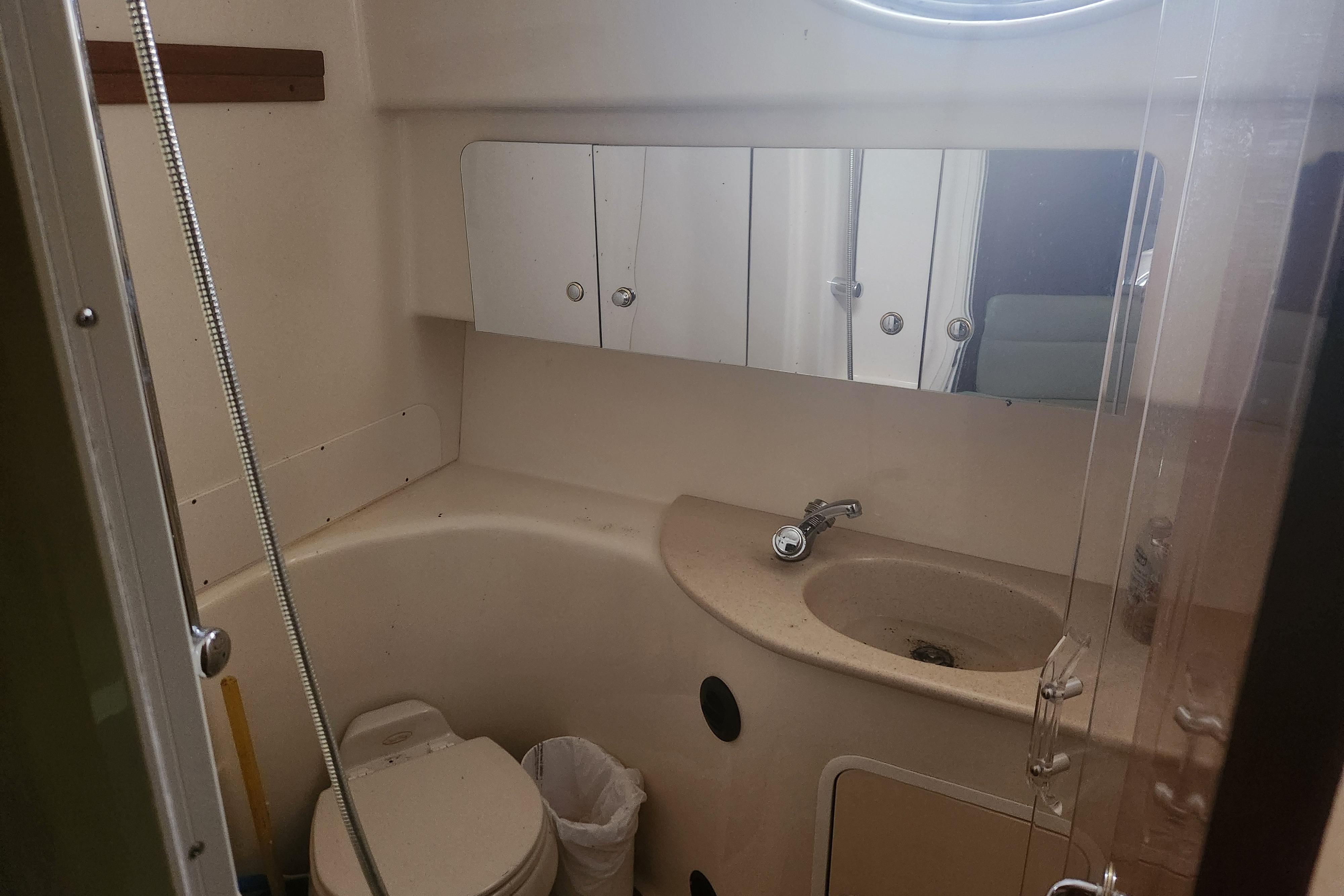 Bathroom interior of 2003 Sea Ray 360 Sundancer yacht, featuring sink and toilet.
