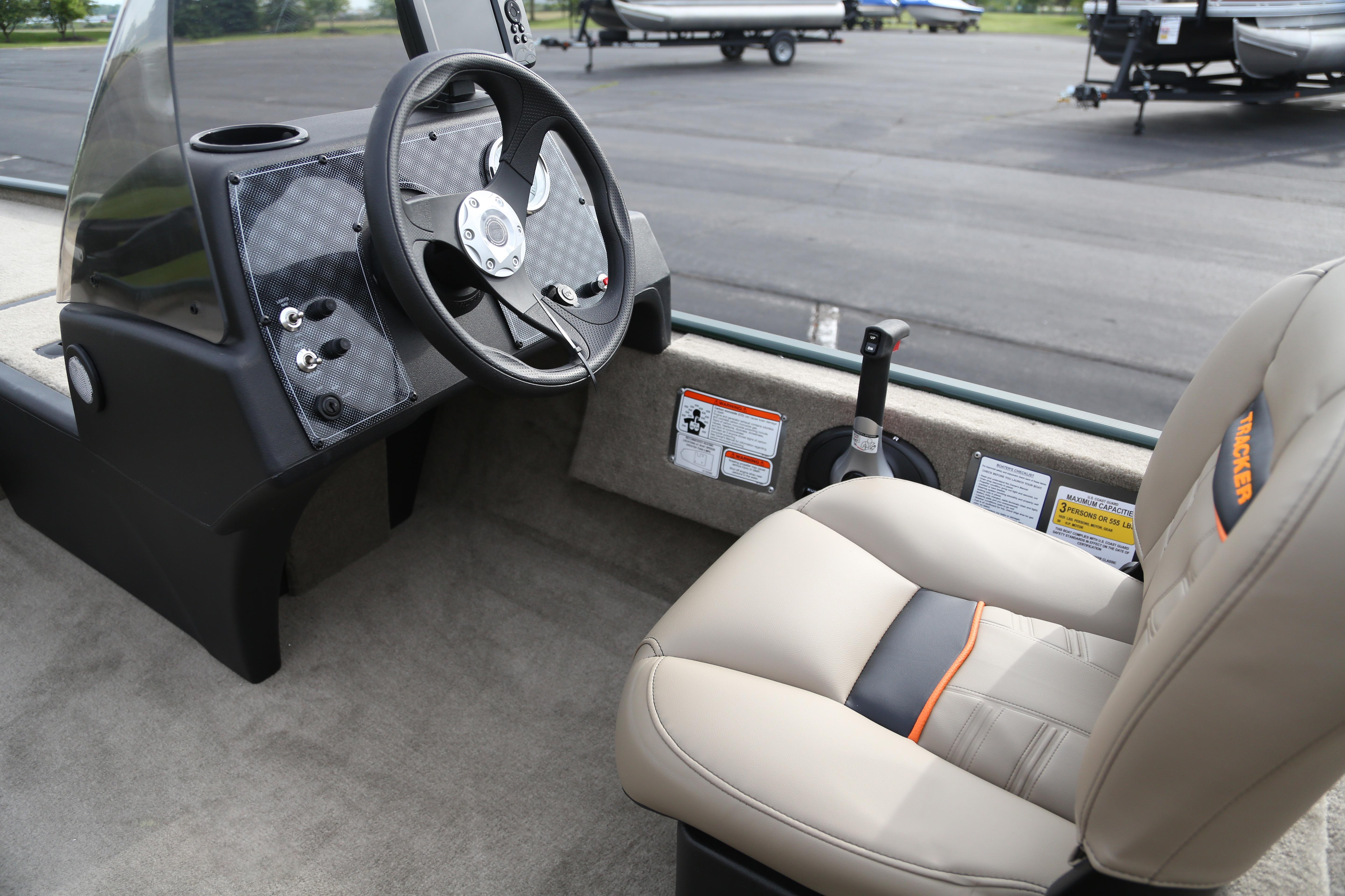 2026 Tracker Bass Tracker Classic Limited boat interior with steering wheel and seat.