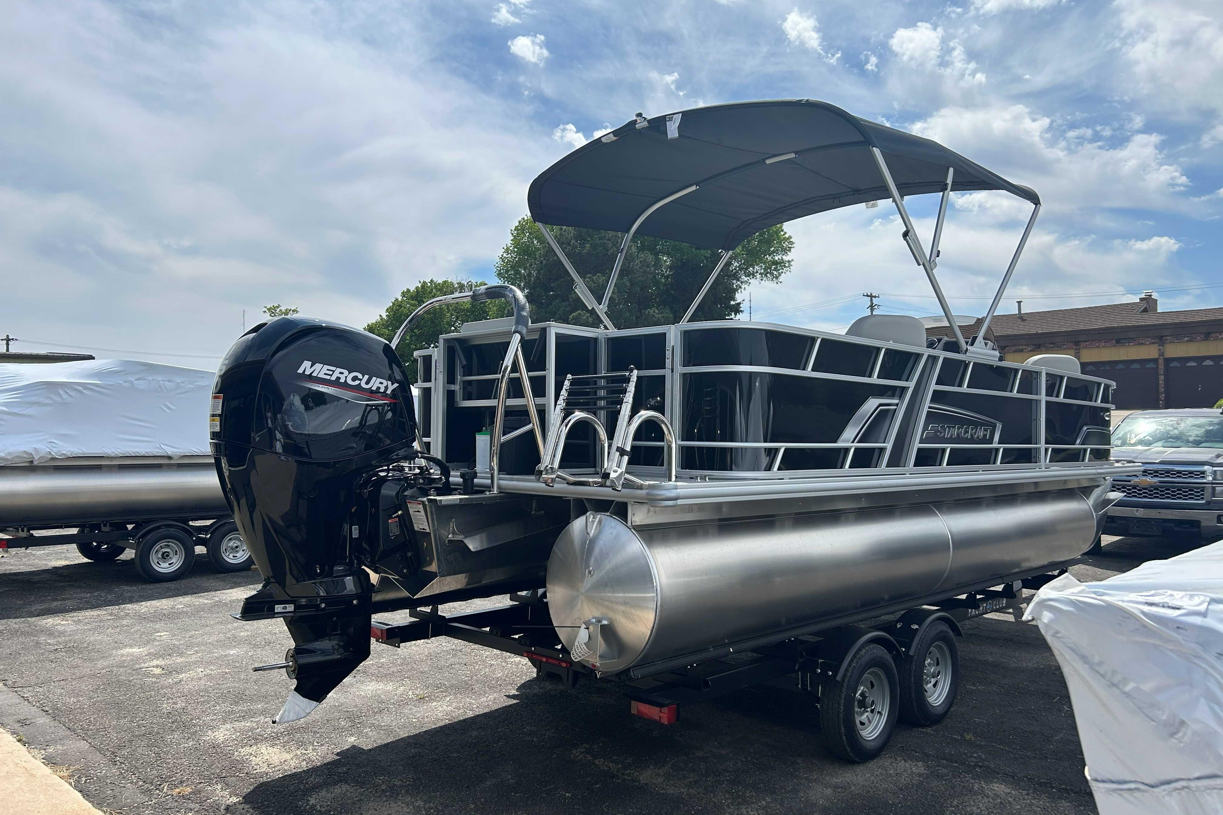 2026 Starcraft EX 22 FD pontoon boat with Mercury outboard motor on trailer.