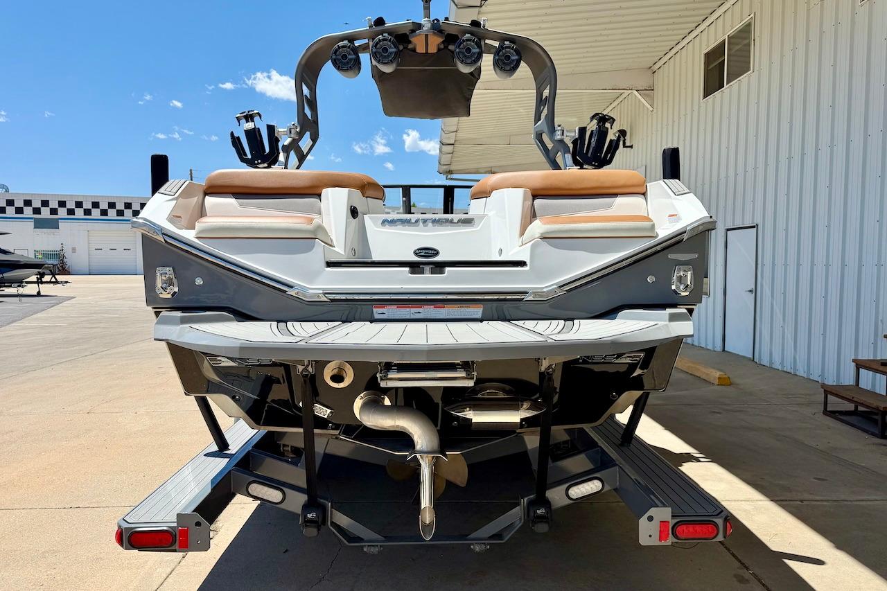 2021 Nautique Super Air Nautique G23 boat rear view at a marina.