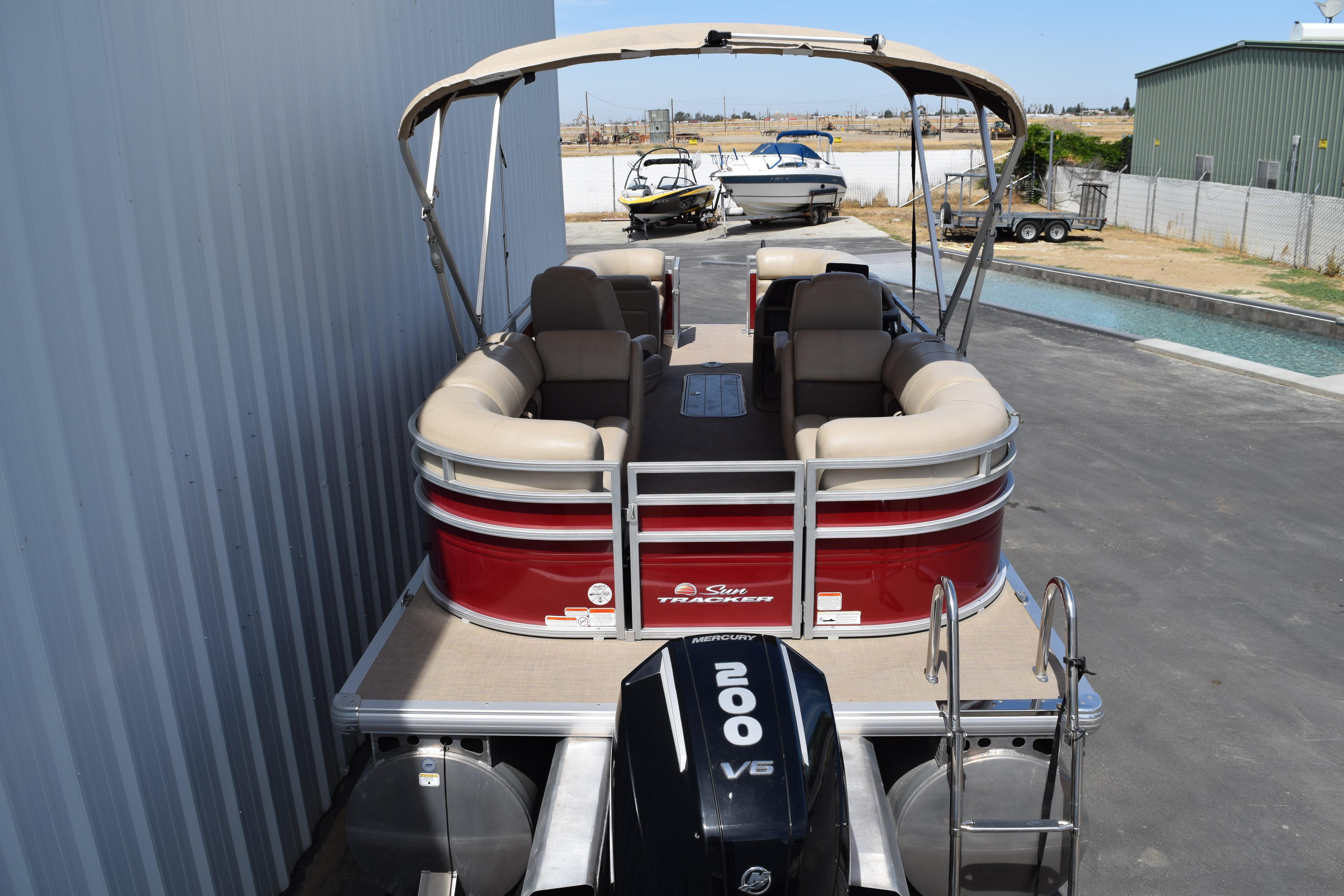 2025 Sun Tracker Party Barge 22 XP3 pontoon boat with canopy and Mercury 200 V6 engine.