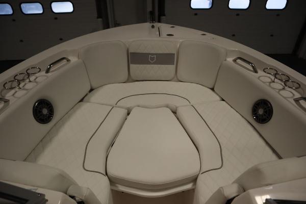 2025 Sea Fox 228 Traveler boat interior with cushioned seating and cup holders.