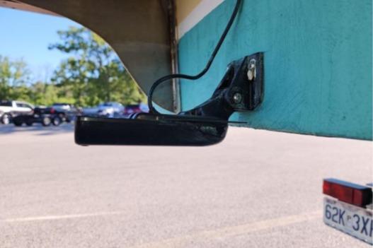 1985 Wasque Down East Cruiser with a mounted sensor in a parking lot.