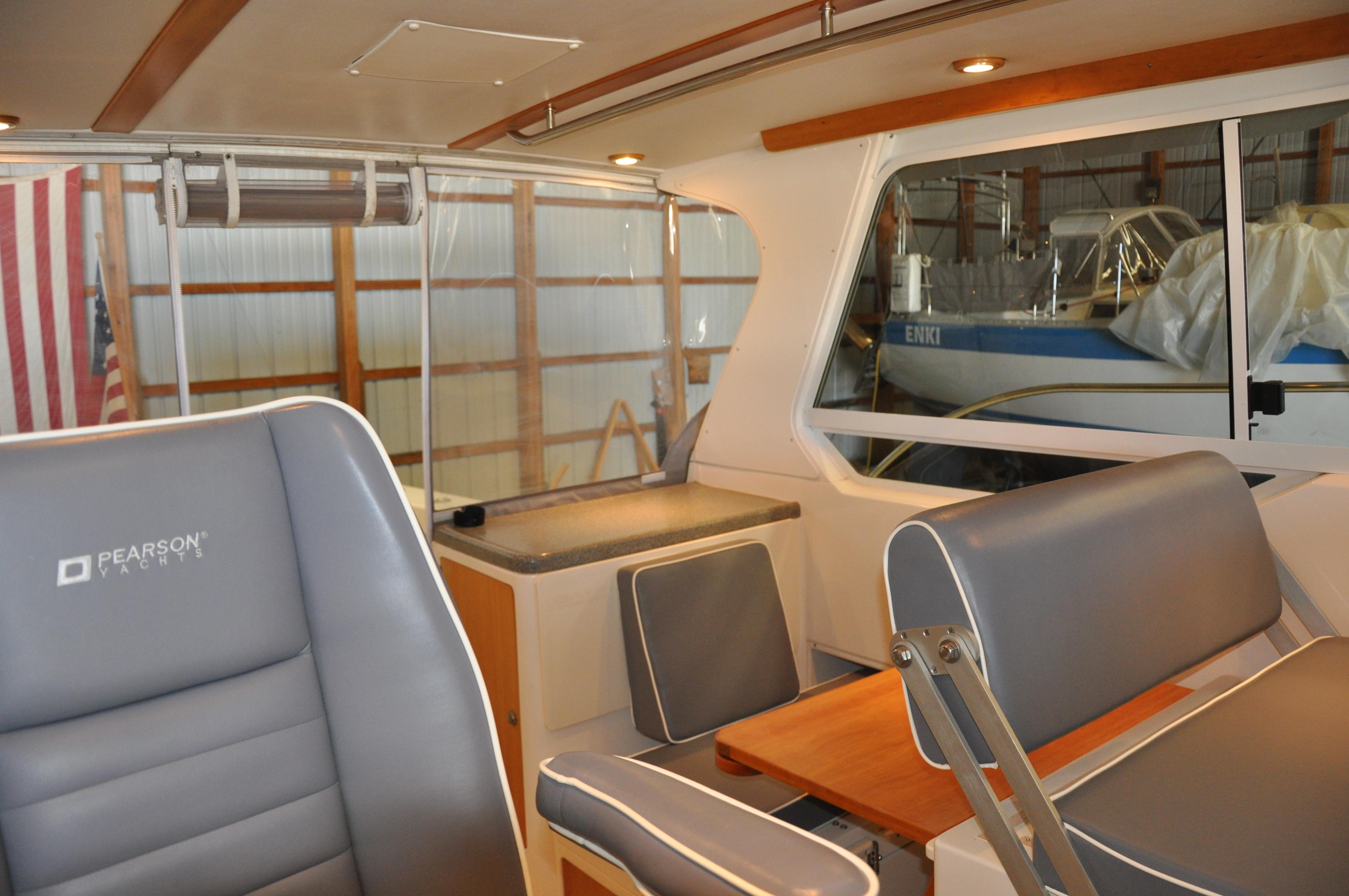 Interior of 2005 True North 33 boat with gray seating and wooden accents.