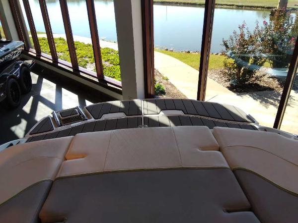 2023 Tahoe 210 Si Limited boat interior with lake view through large windows.