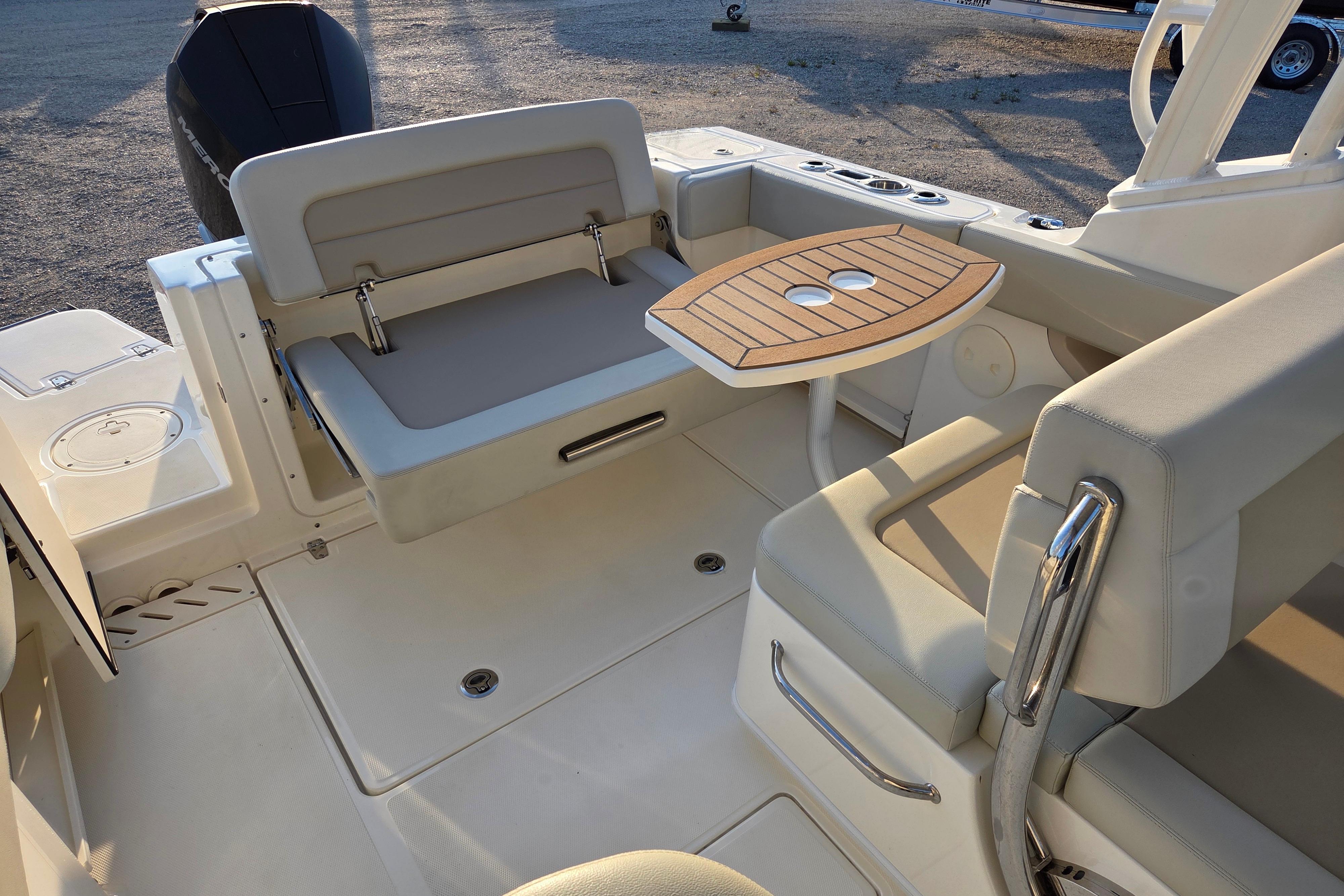 2021 Boston Whaler 240 Vantage boat interior with seating and wooden table.