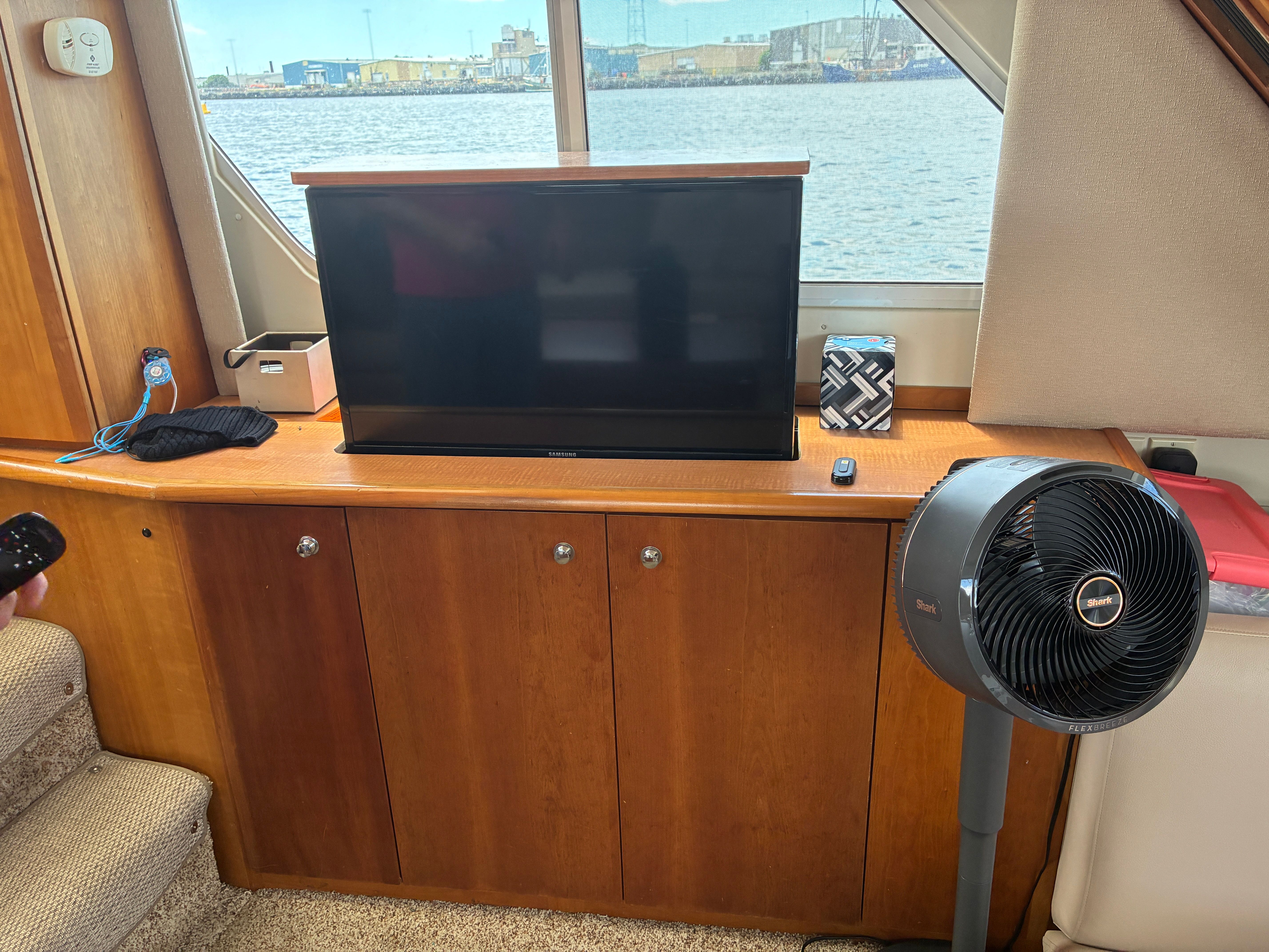 Interior of a 2001 Silverton 392 Motor Yacht with a TV and fan.