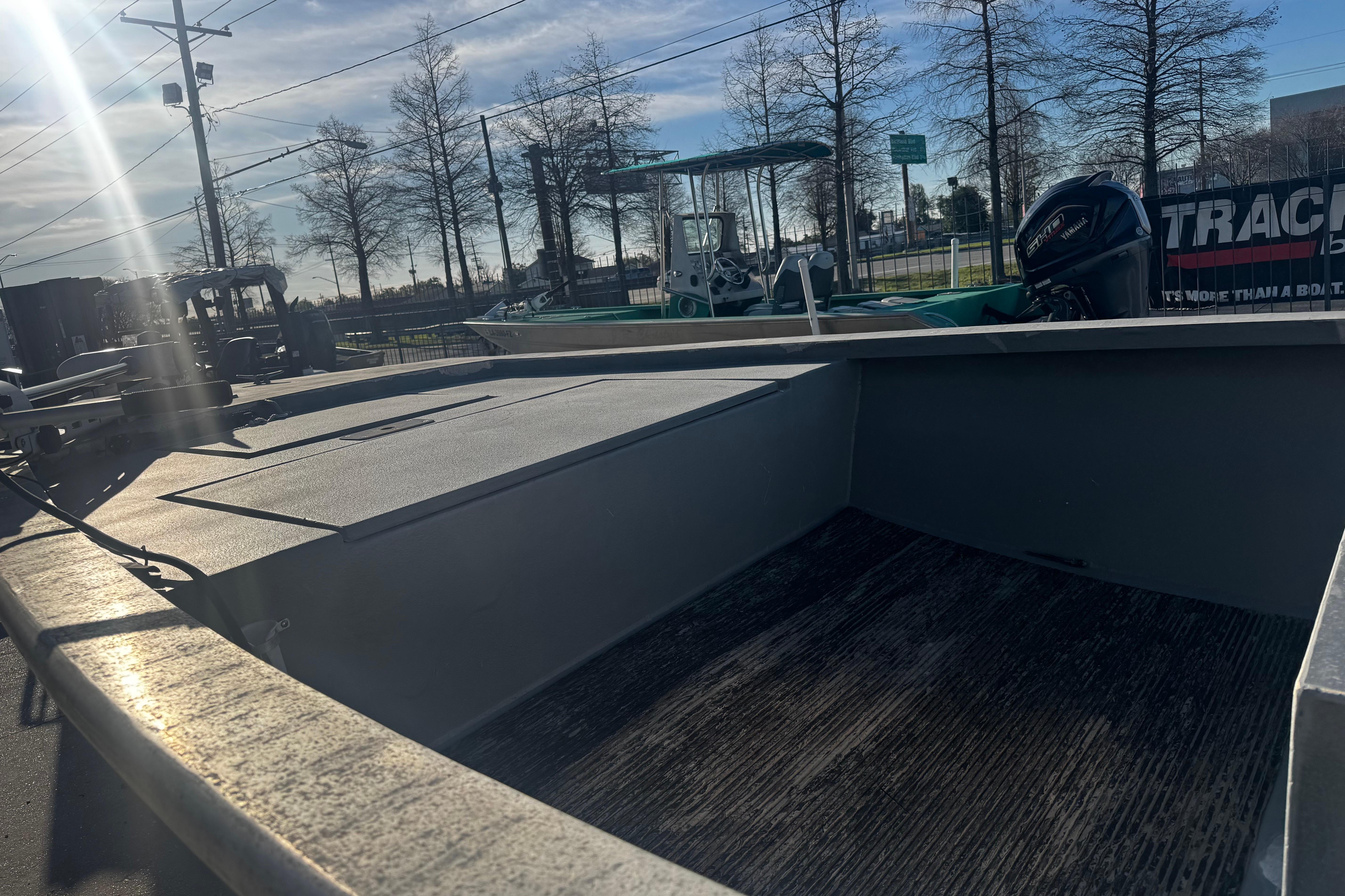 Open deck of a 2004 Custom Charles Leonard 21 boat under sunlight.