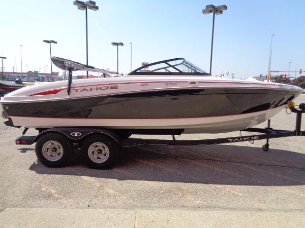 2023 Tahoe 210 Si boat on a trailer in a parking lot.