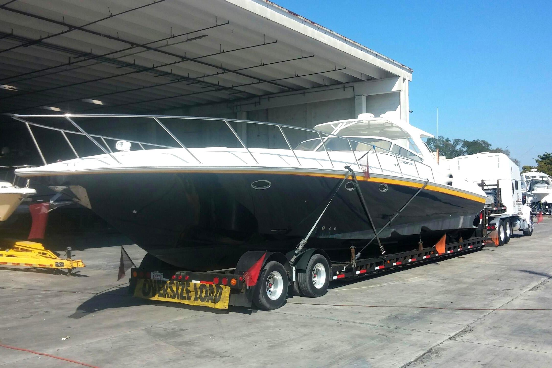 2005 Fountain 48 Express Cruiser on trailer, parked in a boatyard.